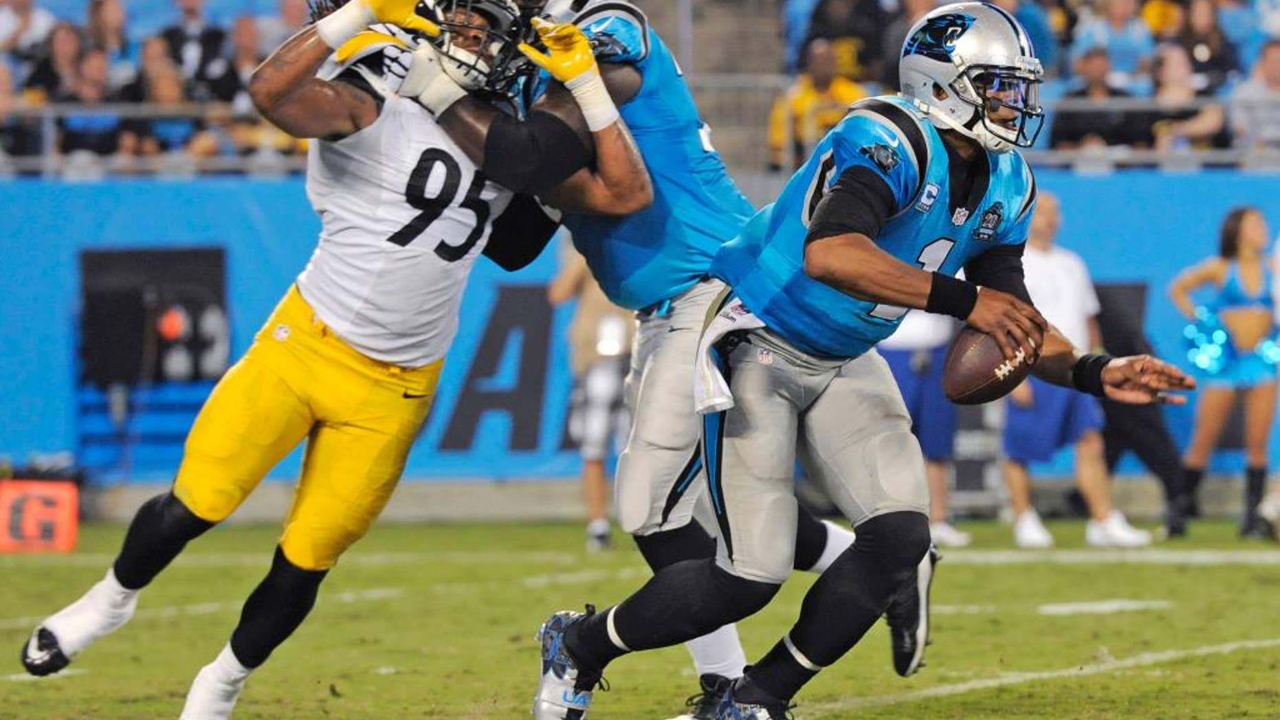 Carolina Panthers' Cam Newton (1) scrambles past Pittsburgh Steelers' Jarvis Jones (95) during the second half of an NFL football game in Charlotte, N.C., Sunday, Sept. 21, 2014. (AP Photo/Mike McCarn)