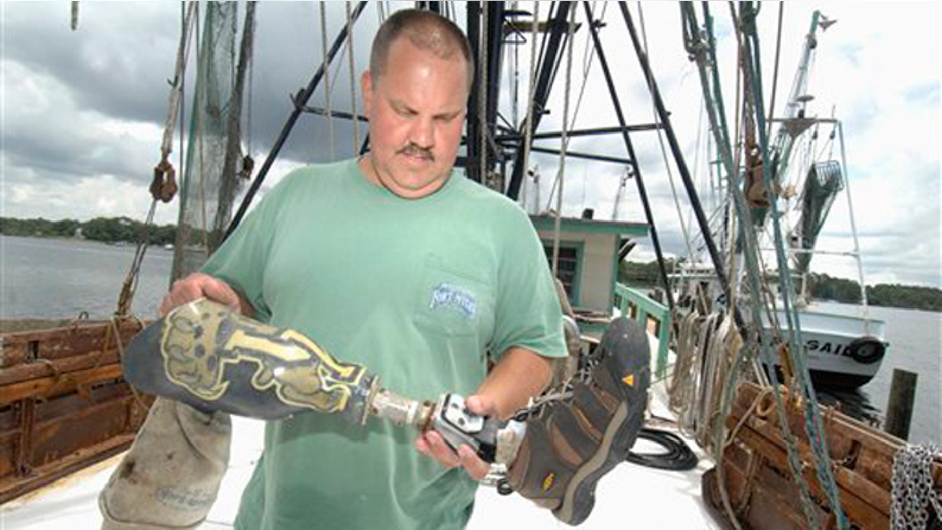 June 7, 2012: Matt Willingham, owner of the shrimp boat Michele Dawn, looks for identifying features on a prosthetic leg at his dock in Valapraiso, Fla.