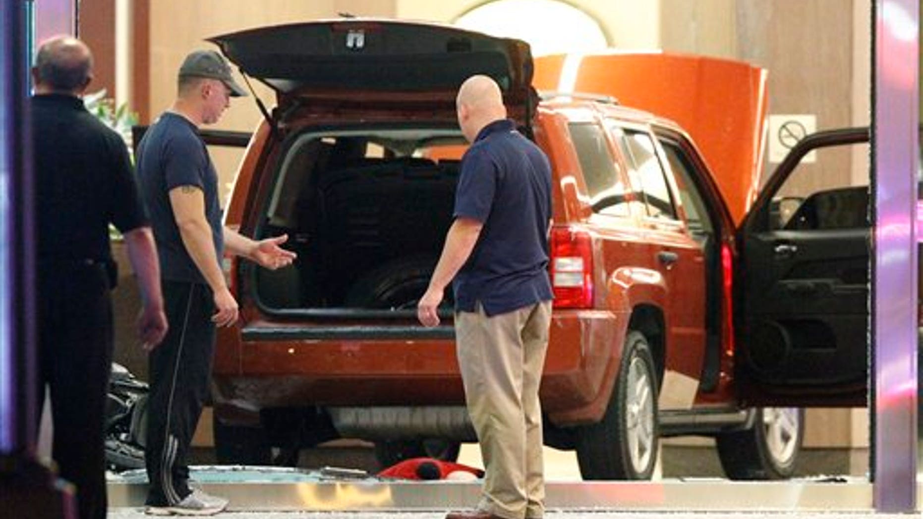 June 8, 2012: FBI investigators and police are on the scene after a sports utility vehicle crashed into an office building at 1050 Connecticut Avenue NW in Washington.