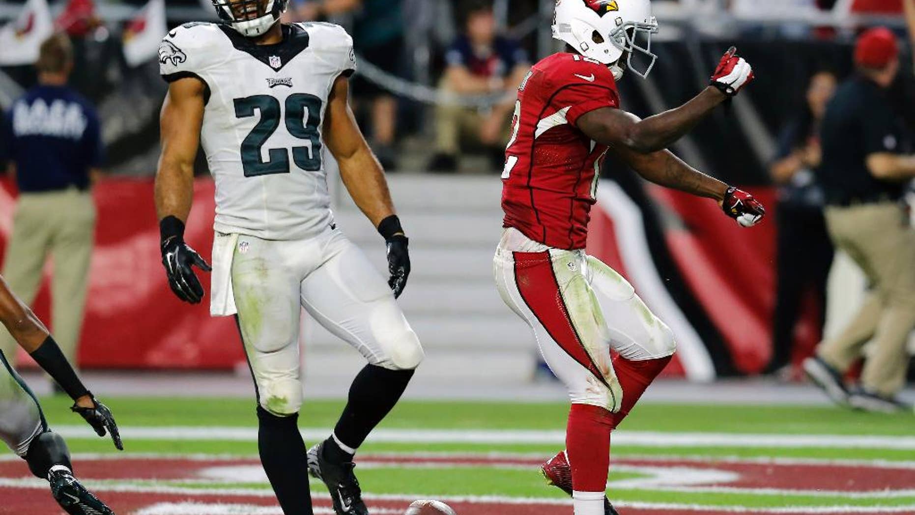 Arizona Cardinals wide receiver John Brown (12) celebrates his touchdown as Philadelphia Eagles strong safety Nate Allen (29) walks away during the second half of an NFL football game, Sunday, Oct. 26, 2014, in Glendale, Ariz. (AP Photo/Rick Scuteri)