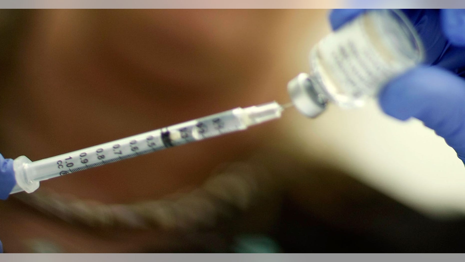 MIAMI - NOVEMBER 03: Marina Spelzini, a registered nurse, measures out an H1N1 vaccine shot at the Miami Dade County Health Department downtown clinic on November 3, 2009 in Miami, Florida. Unlike other parts of the country which are experiencing long lines and shortages of the vaccine, South Florida is not having this problem. The Miami-Dade County Health Department received 195,000 doses of the vaccine but has only given out about 10,100. Broward County has 52,000 doses on hand and has administered about 10,000 doses. (Photo by Joe Raedle/Getty Images)