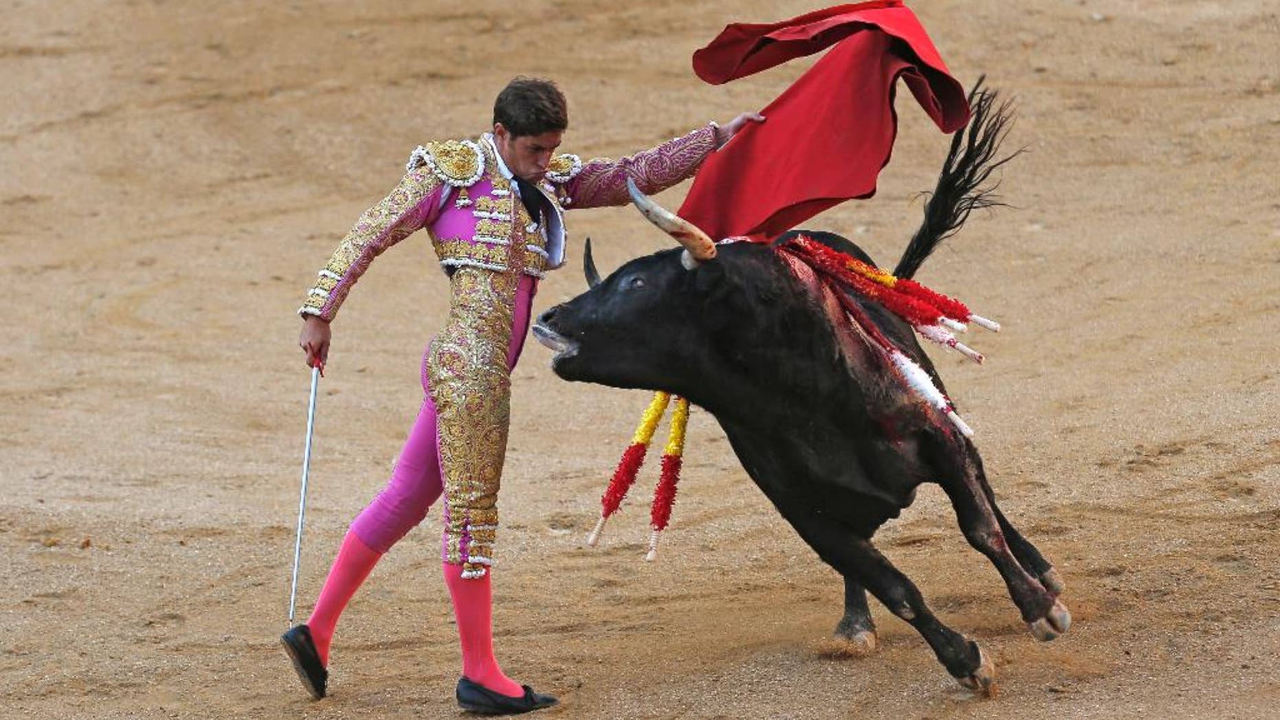 FILE - In a Sunday, Oct. 9, 2016 file photo, Spanish bullfighter Mario Palacios performs with an Aguadulce ranch fighting bull during a bullfight at the Las Ventas bullring in Madrid, Spain. Spain's top court on Thursday, Oct. 20, 2016 overruled a local ban against bullfighting in the powerful northeastern region of Catalonia, saying it violated a national law protecting the spectacle. (AP Photo/Francisco Seco, File)