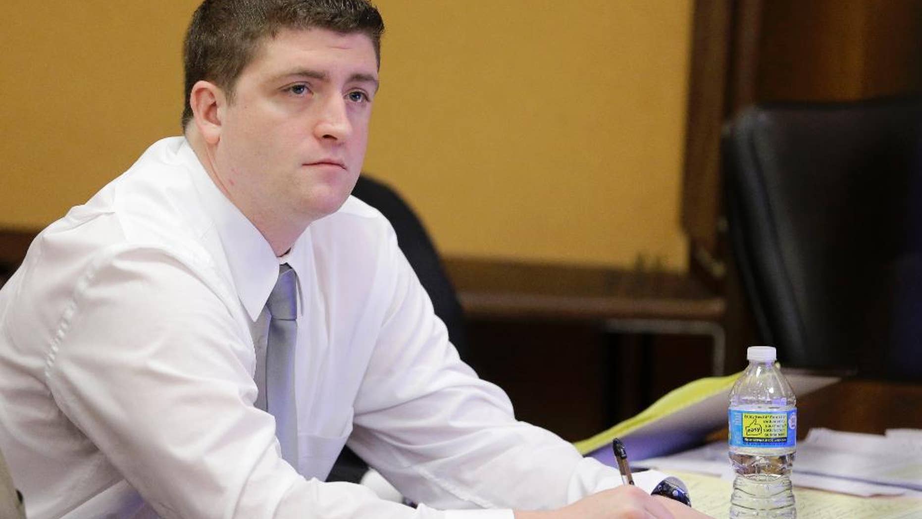FILE - In this April 9, 2015, file photo, Cleveland police Officer Michael Brelo listens to testimony during his trial in Cleveland. Attorneys are scheduled to give closing arguments, Tuesday, May 5, 2015, in the trial of Brelo, charged in the deaths of two unarmed people in a 137-shot barrage of police gunfire. (AP Photo/Tony Dejak, Pool, File)