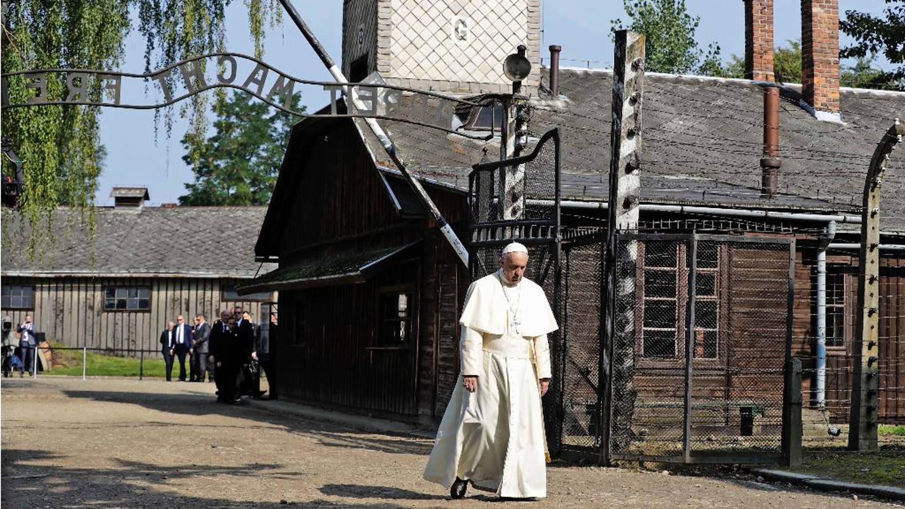 July 29, 2016: Pope Francis walks through the gate of the former Nazi German death camp of Auschwitz in Oswiecim, Poland.
