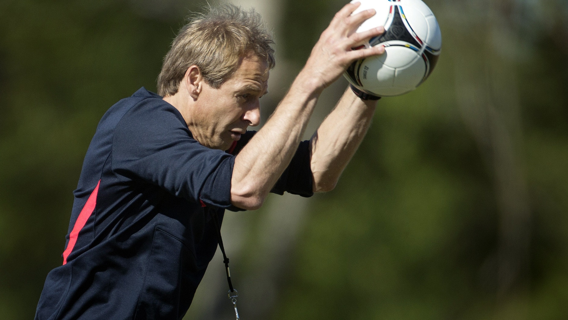 Coach Jurgen Klinsmann slams the ball to the ground during a U.S. Men's National Team practice at the FIU Soccer Stadium, Monday, Feb. 4, 2013, in Miami. The team is gathering in Miami prior to traveling to face Honduras in the opening match of Final Round qualifying for the 2014 FIFA World Cup on Feb. 6 in San Pedro Sula. (AP Photo/J Pat Carter)