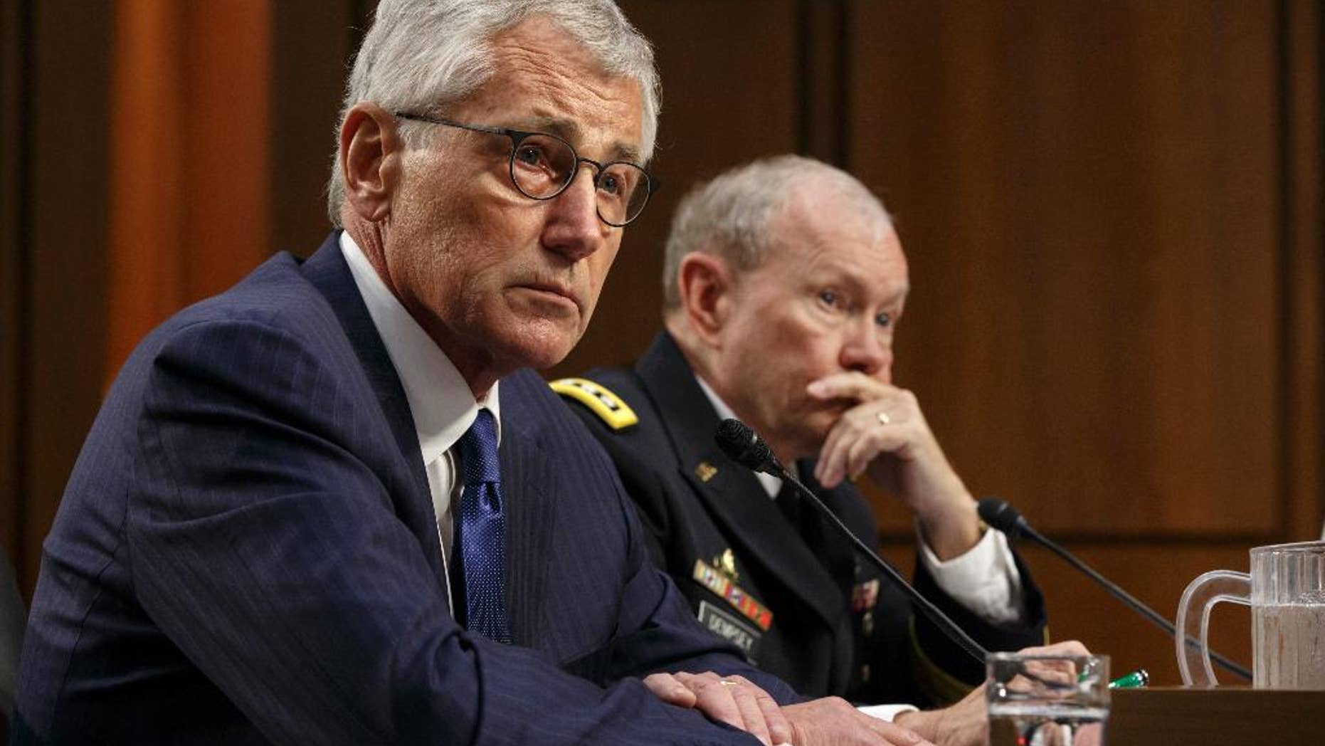 Defense Secretary Chuck Hagel, left, and Army Gen. Martin Dempsey, chairman of the Joint Chiefs of Staff, appear before the Senate Armed Services Committee, the first in a series of high-profile Capitol Hill hearings that will measure the president's ability to rally congressional support for President Barack Obama's strategy to combat Islamic State extremists in Iraq and Syria, in Washington, Tuesday, Sept. 16, 2014. Obama last week outlined his military plan to destroy the extremists, authorizing U.S. airstrikes inside Syria, stepping up attacks in Iraq and deploying additional American troops, with more than 1,000 now advising and assisting Iraqi security forces to counter the terrorism threat. (AP Photo/J. Scott Applewhite)