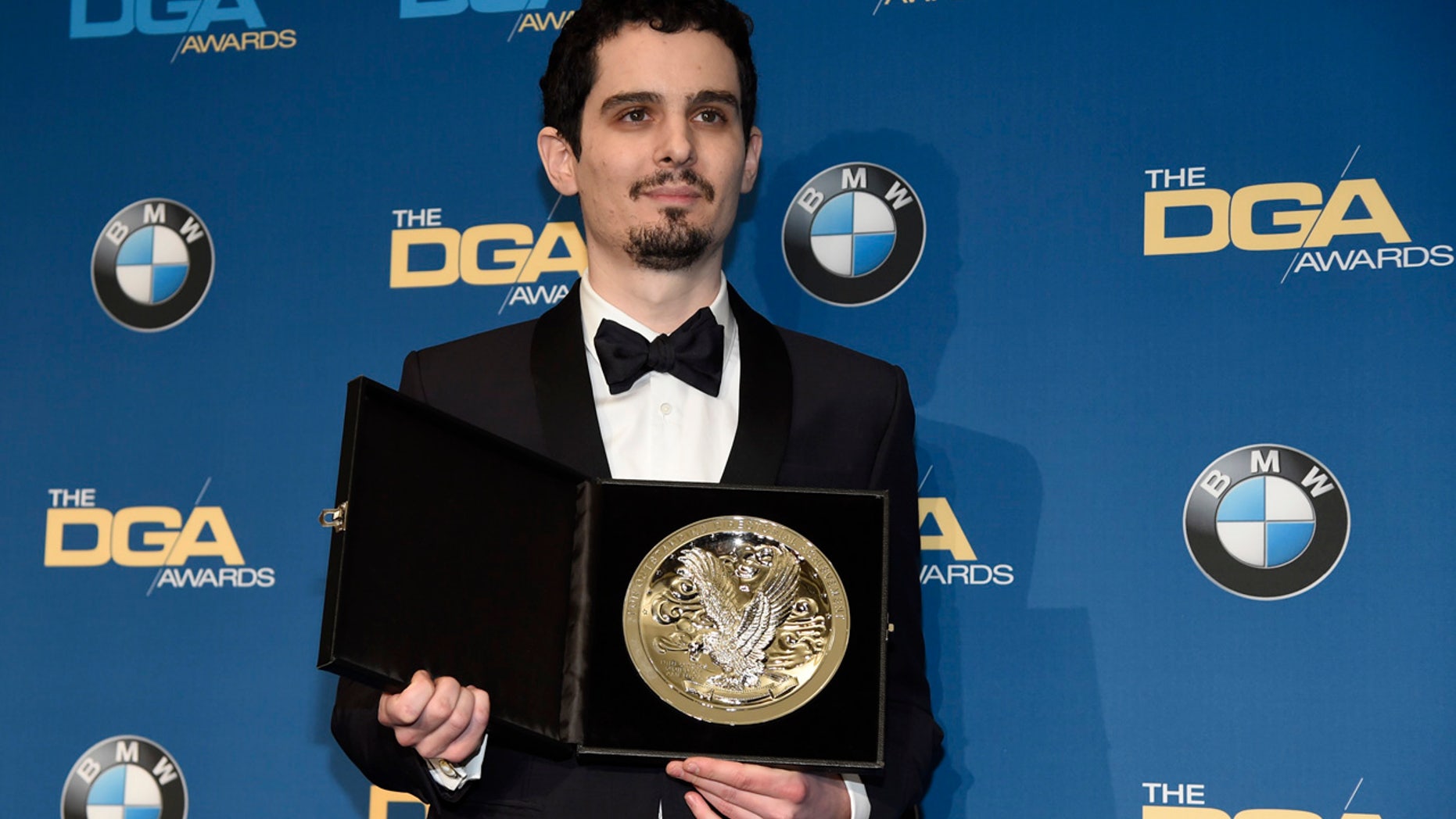Damien Chazelle, director of "La La Land," holds his nominee's medallion backstage at the 69th annual Directors Guild of America Awards at the Beverly Hilton on Saturday, Feb. 4, 2017, in Beverly Hills, Calif.