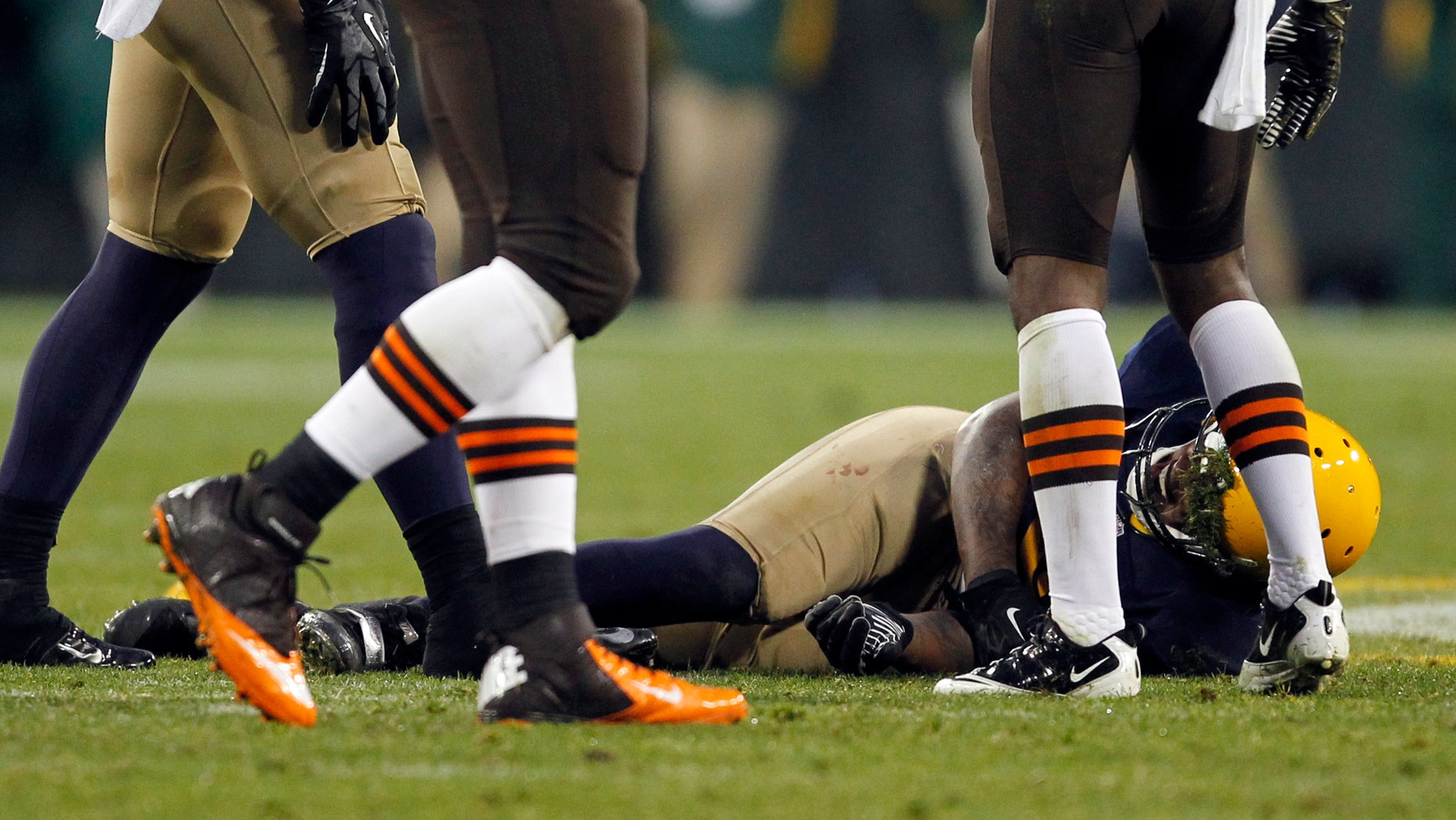 Green Bay Packers' Jermichael Finley lays on the field after being injured during the second half of an NFL football game against the Cleveland Browns Sunday, Oct. 20, 2013, in Green Bay, Wis. Finley left the game on a stretcher. (AP Photo/Mike Roemer)