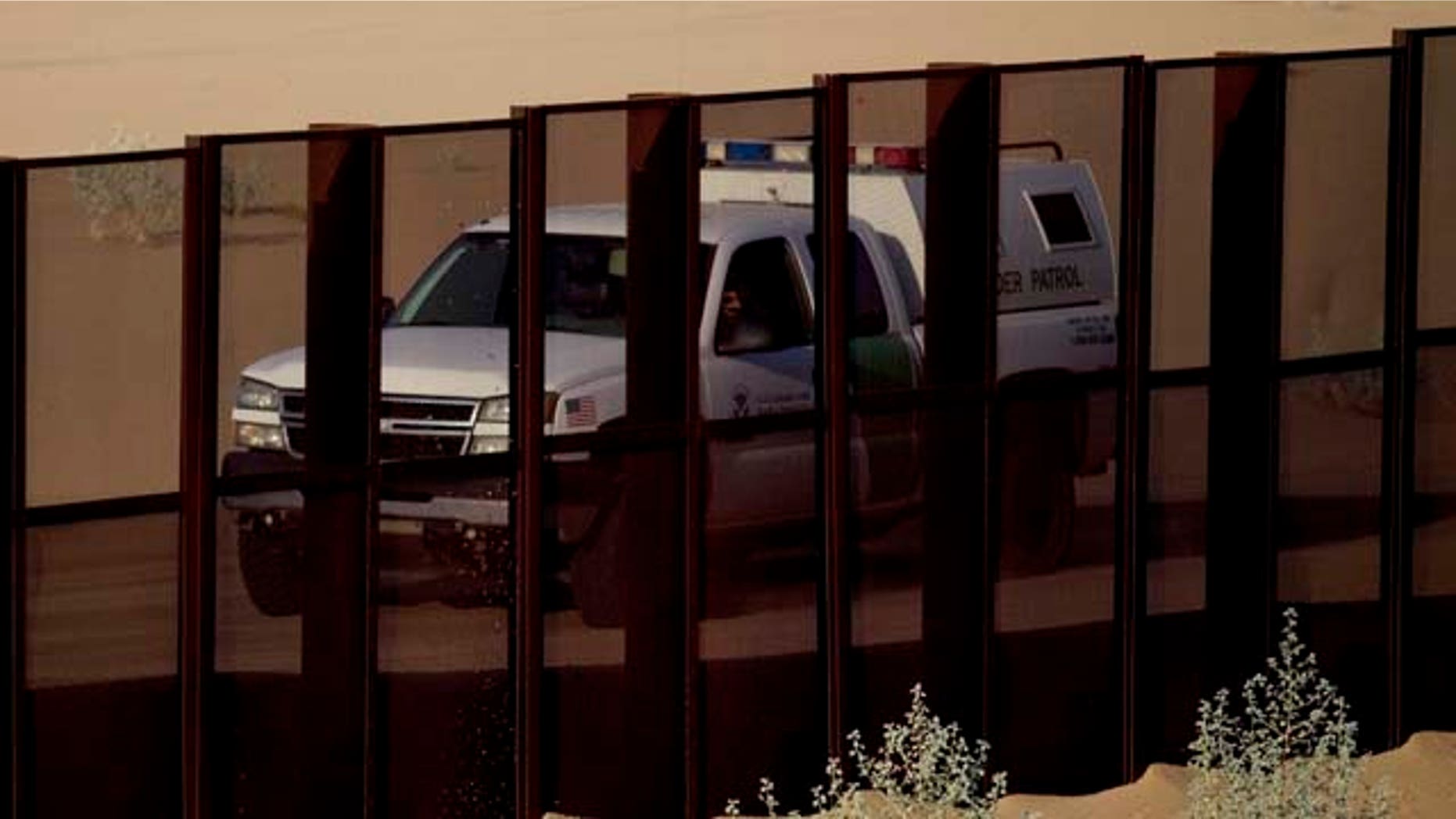 FILE In this July 28, 2010 photo, a US border patrol vehicle drives along the U.S.-Mexico border fence near Yuma, Ariz., as seen from the outskirts of San Luis Rio Colorado, Mexico. Arizona launched a website Wednesday, July 20, 2011, to accept donations to pay for fencing along the Mexico border, and a supporter says the $3.8 million people donated to defend the state's 2010 immigration enforcement law could be just a taste of what to expect. (AP Photo/Guillermo Arias)