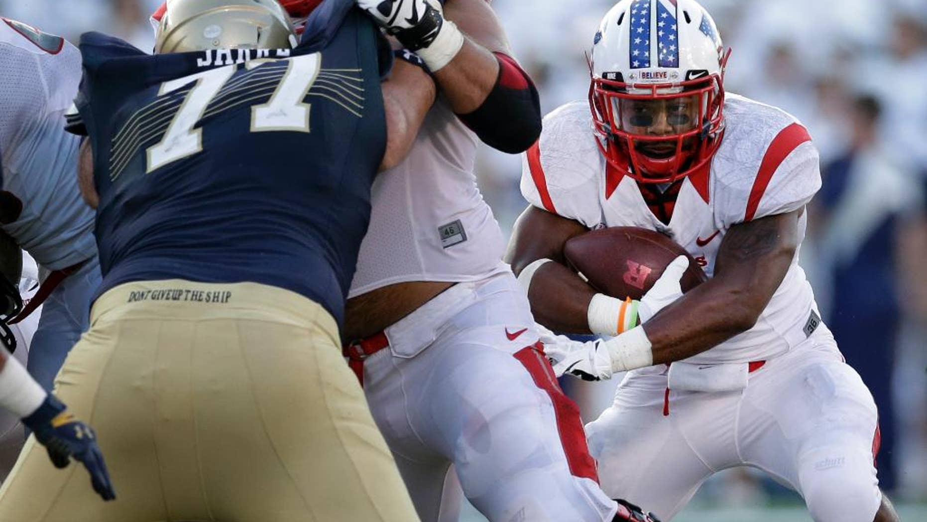 Rutgers running back Desmon Peoples, right, rushes the ball in the first half of an NCAA college football game against Navy in Annapolis, Md., Saturday, Sept. 20, 2014. (AP Photo/Patrick Semansky)