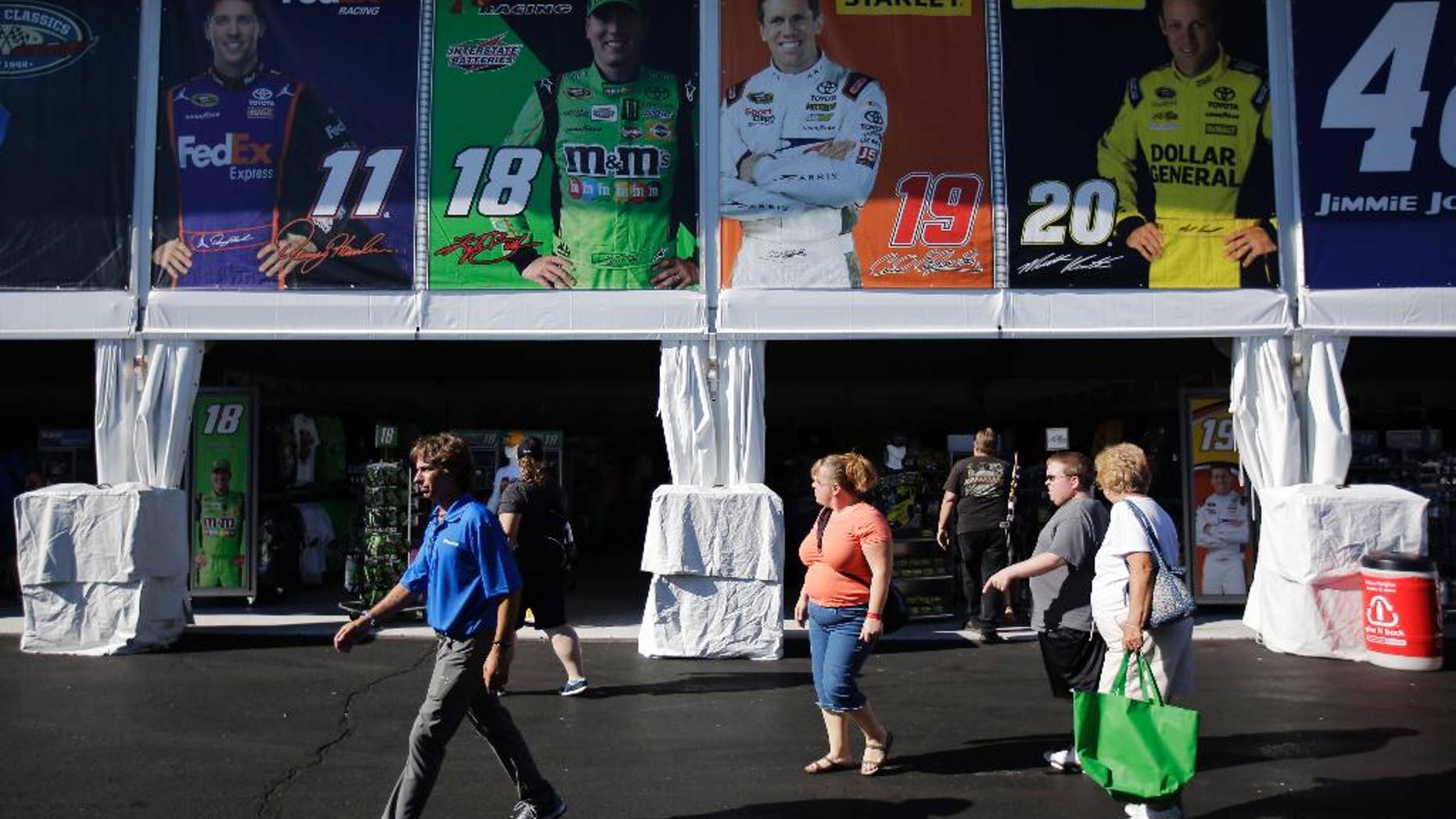 Fans walk through new souvenir superstore behind the grandstands at Pocono Raceway, Friday, July 31, 2015, in Long Pond, Pa. The raceway hosts the NASCAR Pocono 400 auto race on Sunday. (AP Photo/Matt Slocum)