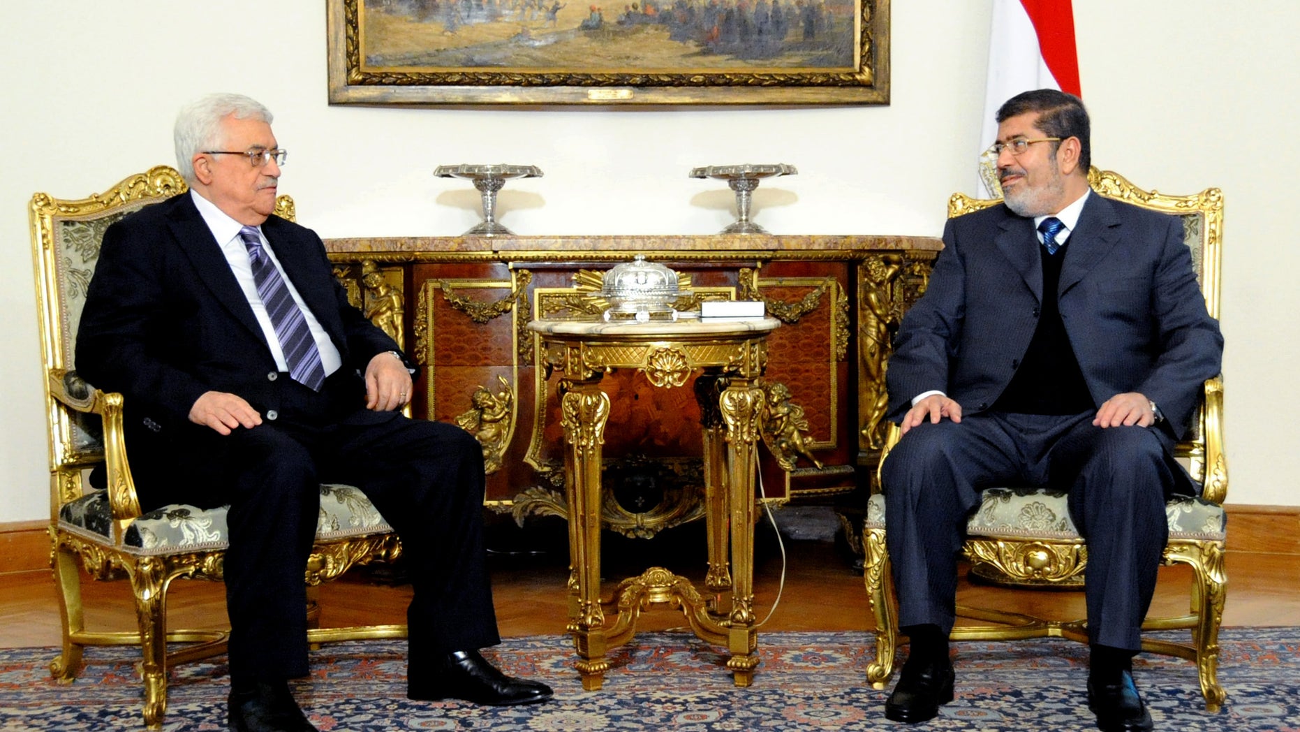 In this image released by the Egyptian Presidency, Egyptian President Mohammed Morsi, right, meets with Palestinian President Mahmoud Abbas at the Presidential Palace in Cairo, Egypt, Wednesday, Jan. 9, 2013. (AP Photo/Egyptian Presidency)