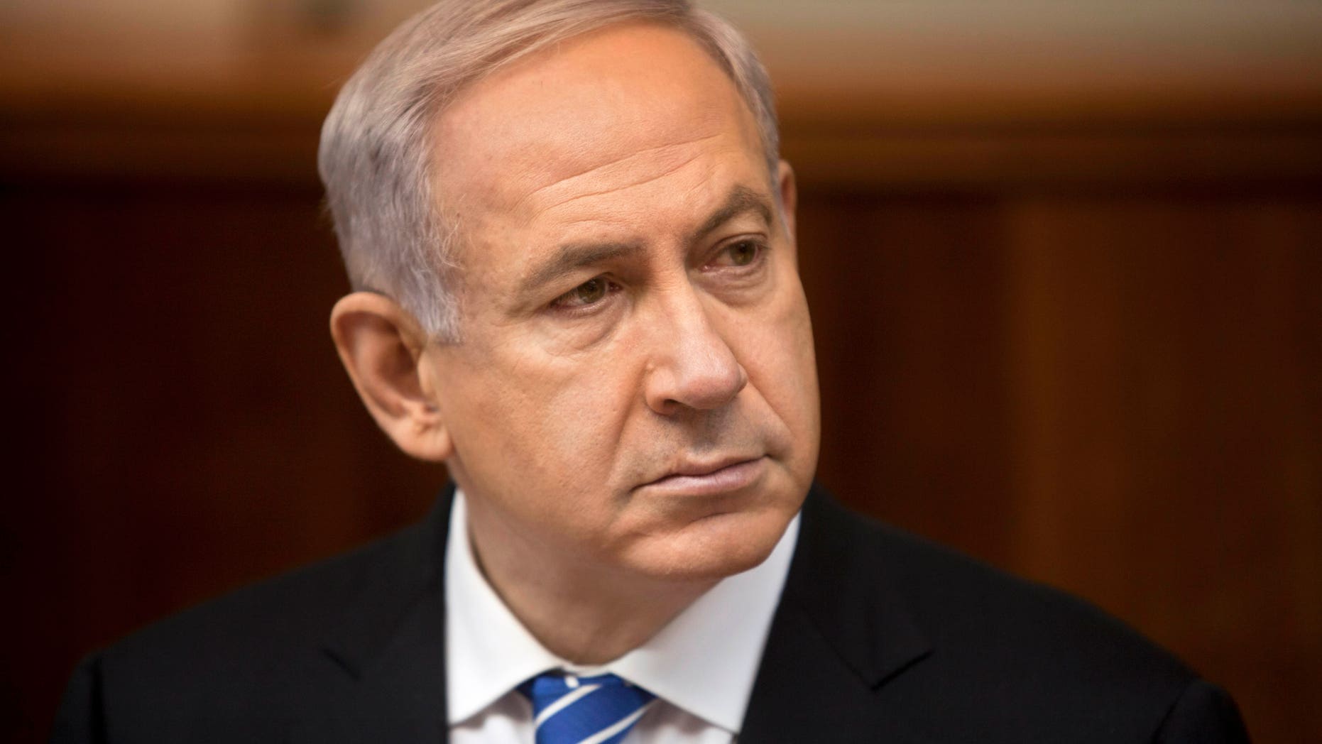 File - In this March 10, 2013 file photo, Israeli Prime Minister Benjamin Netanyahu attends the weekly cabinet meeting in his Jerusalem office. Netanyahu held out the possibility on Thursday, April 18, 2013 of arming Syrian rebels, saying in a televised interview that the decision on whether to intervene in the civil war is a “complicated question” because of the myriad groups taking part in the violence.(AP Photo/Sebastian Scheiner, File)