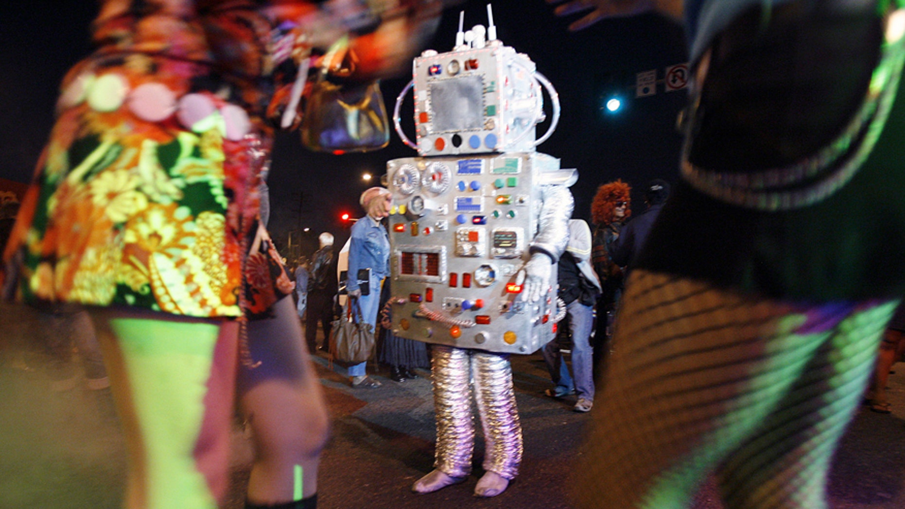 File photo: People in costume dance during the 19th annual Halloween costume carnaval in West Hollywood, California October 31, 2006. (REUTERS/Mario Anzuoni)