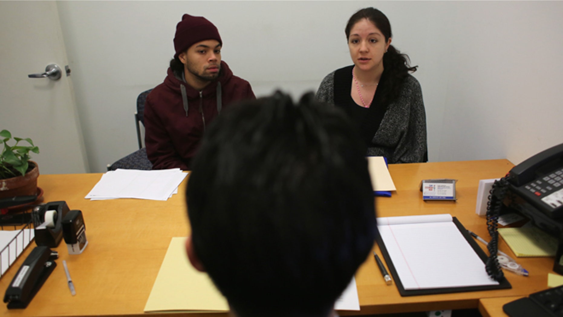 NEW YORK, NY - JANUARY 31: Immigration lawyer Andres Lemons advises Angel and Evie Gomez on their U.S. citizenship application on January 31, 2013 in New York City. The married couple, he from the Dominican Republic, and she from Canada are soon to have a baby and are working through the long process to become U.S. citizens. Lemons works at the CUNY Citizenship Now "Express Center" in New York's Washington Heights. The non-profit helps some 8,000 immigrants in the New York area navigate through the complicated process of acquiring U.S. Citizenship and provides free legal information for the immigrant community. (Photo by John Moore/Getty Images)