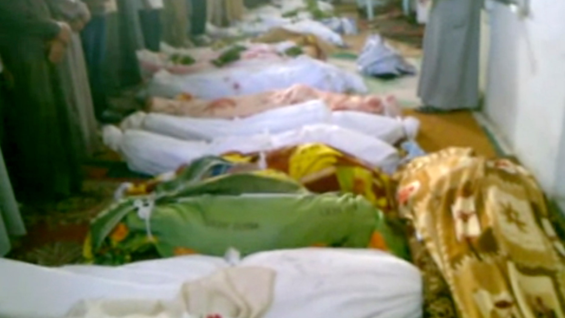 July 13, 2012: This image made from amateur video from Hama Revolution 2011 and accessed by AP video purports to show bodies of victims killed by violence that, according to anti-regime activists, was carried out by government forces in Tremseh, Syria, about nine miles northwest of the central city of Hama.