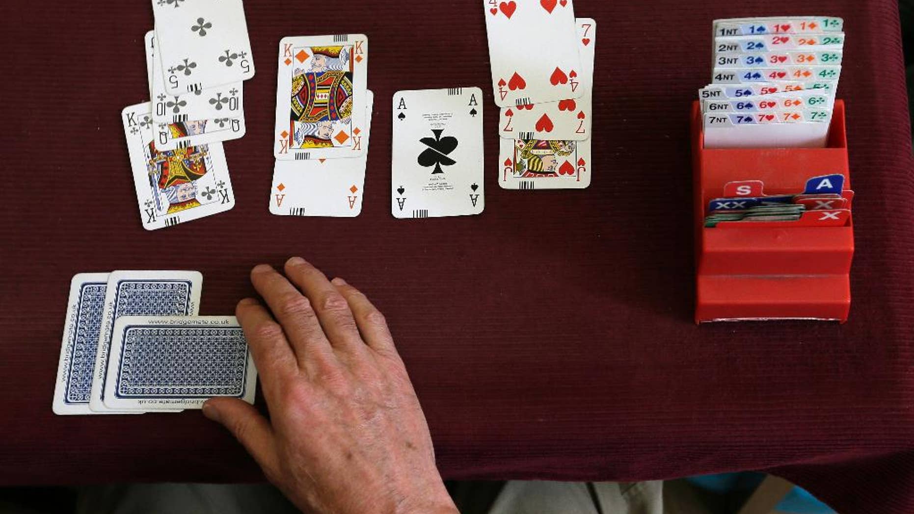 FILE - This is a Tuesday Sept. 22, 2015 file photo of a competitor playing bridge at the Acol Bridge Club in West Hampstead, London. A High Court judge on Thursday Oct. 15, 2015 backed Sport England's assertion that bridge is not a sport because it does not involve physical activity. English Bridge Union officials had challenged the ruling in court. (AP Photo/Tim Ireland, File)