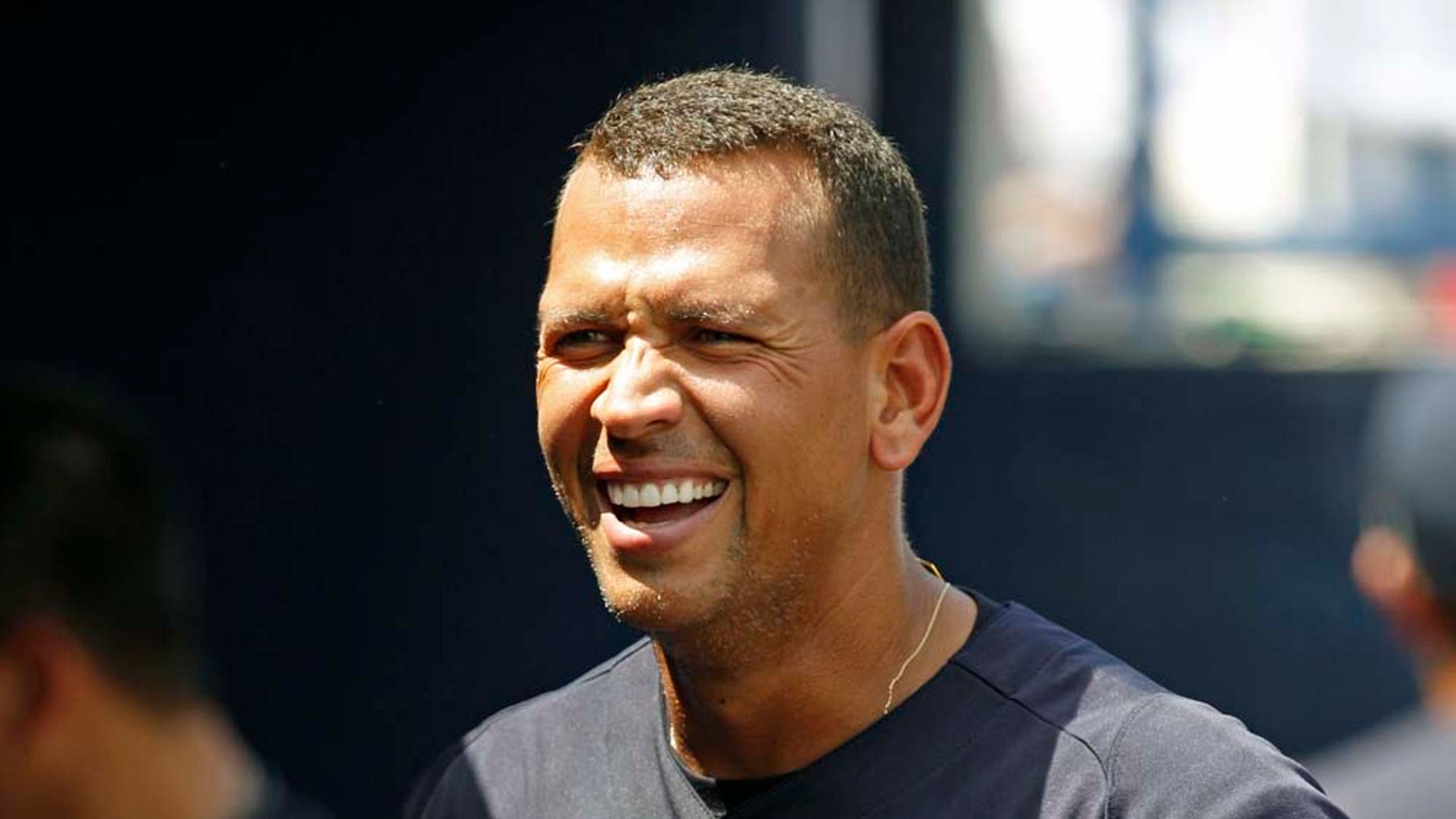 New York Yankees' Alex Rodriguez smiles in the dugout after hitting a two-run home run off Pittsburgh Pirates starting pitcher Kevin Correia in the first inning of a spring training baseball game at Steinbrenner Field in Tampa, Fla., Saturday, March 26, 2011. (AP Photo/Kathy Willens)