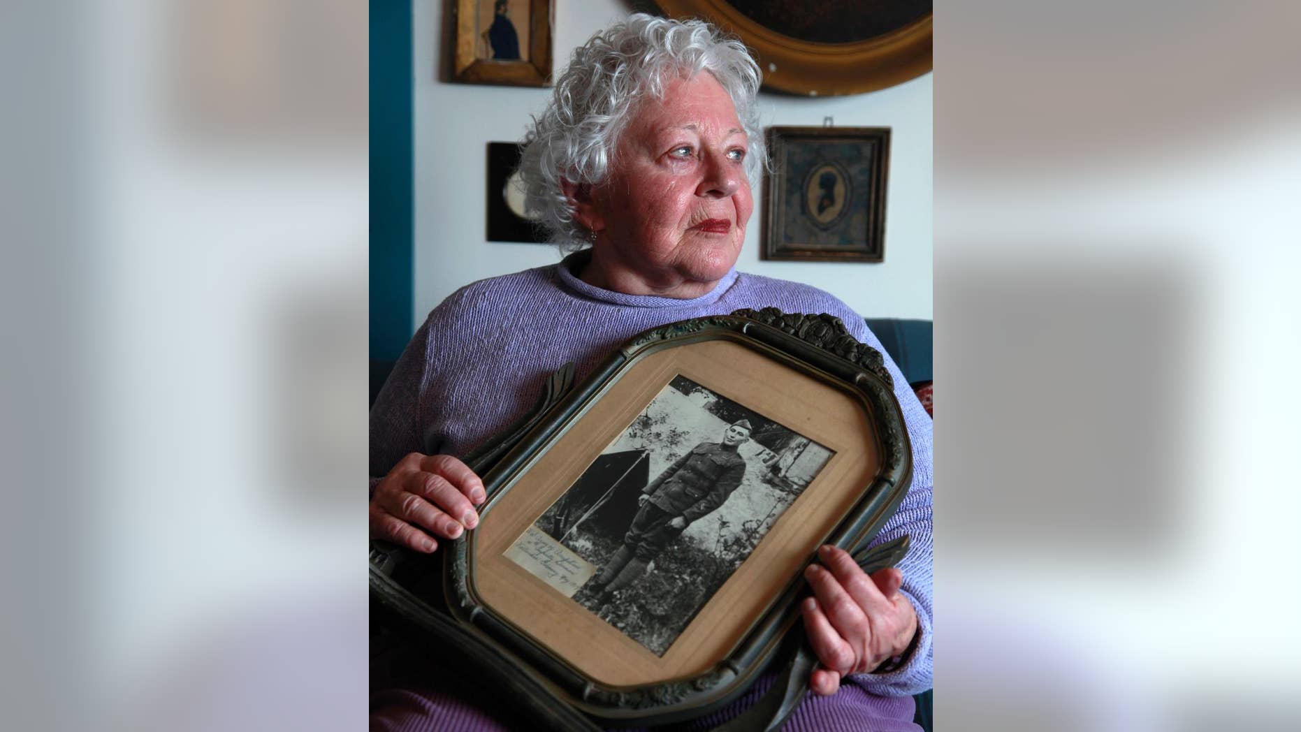 FILE - In this Jan. 5, 2012 file photo Elsie Shemin-Roth holds a World War I photo of her father William Shemin at her home in Labadie, Mo. Nearly a century ago, Sgt. Shemin raced across a battlefield three times to pull wounded comrades to safety, survived a bullet to the head and led his unit to safety. The heroism should have earned him the Medal of Honor but didn't, possibly because discrimination was rampant _ and he was Jewish. Thanks to the efforts of his daughter, Shemin is on the cusp of finally being honored with a medal, 41 years after his death. (AP Photo/Jeff Roberson, File)