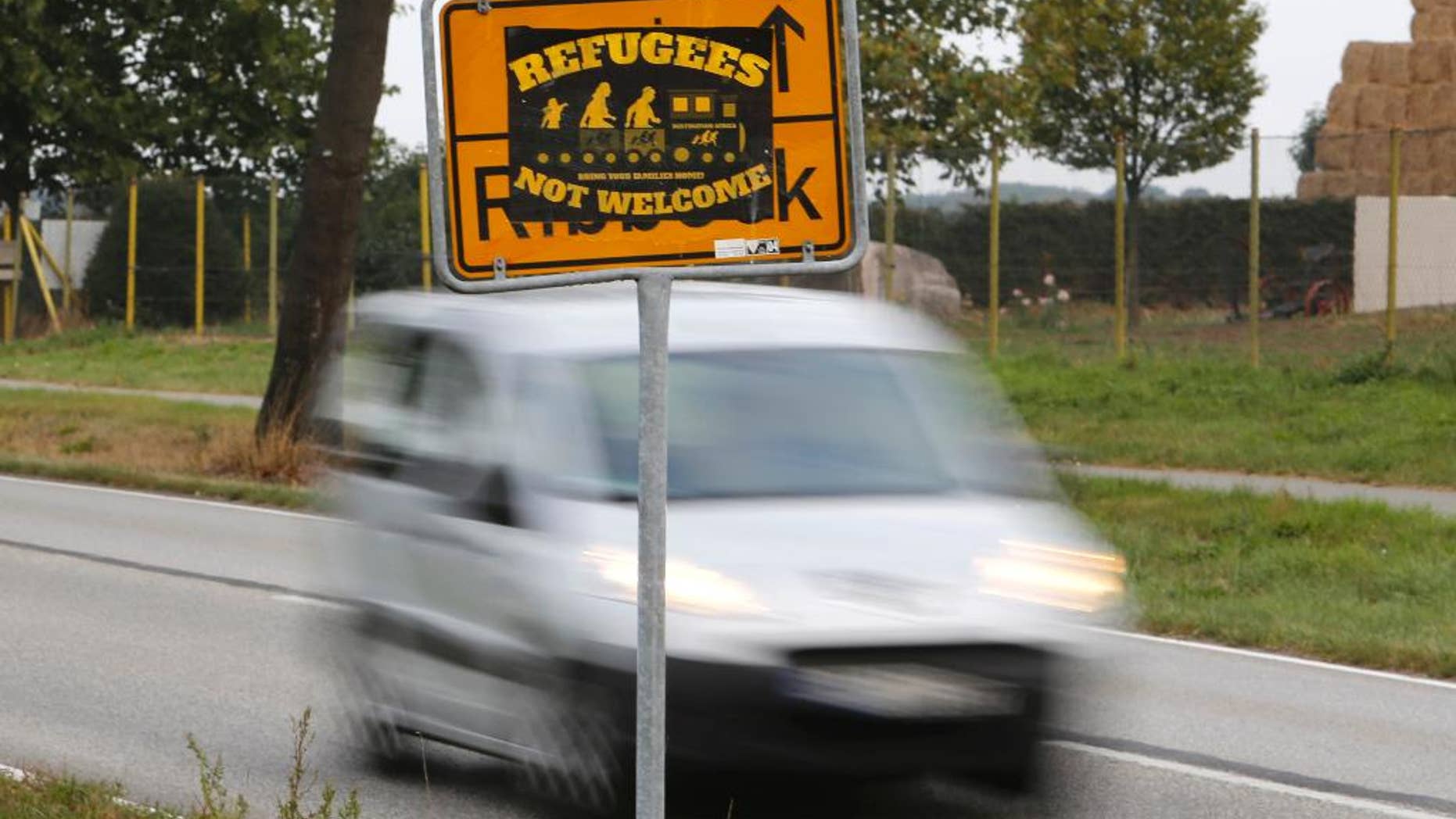 The Sept. 23, 2016 shows a poster 'Refugees not welcome' sticked on a city sign in the outskirts of Nauen, eastern Germany, one of several thousand hate crimes in Germany in 2016. (AP Photo/Ferdinand Ostrop)