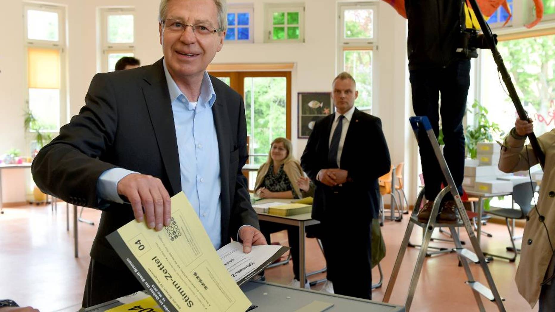 Mayor of Bremen Jens Boehrnsen casts his vote for the state election at a polling station in Bremen, Germany, Sunday, May 10, 2015. Germany's smallest state Bremen has been led by the center-left Social Democrats since the 1940s and polls point to a majority for popular Mayor Boehrnsen's current coalition with the Greens in the regional legislature. (Ingo Wagner/dpa via AP)