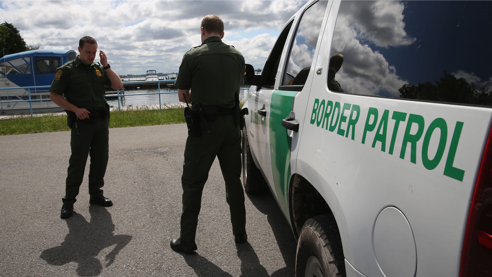 BEAVER ISLAND STATE PARK, NY - JUNE 03: U.S. Border Patrol agents talk while at a marina on the Niagara River at the U.S.-Canada border on June 3, 2013 in Beaver Island State Park, New York. U.S. Customs and Border Protection, which includes the Border Patrol, monitors the 5,525 mile long border, including Alaska, forming the longest international border between two countries in the world. (Photo by John Moore/Getty Images)