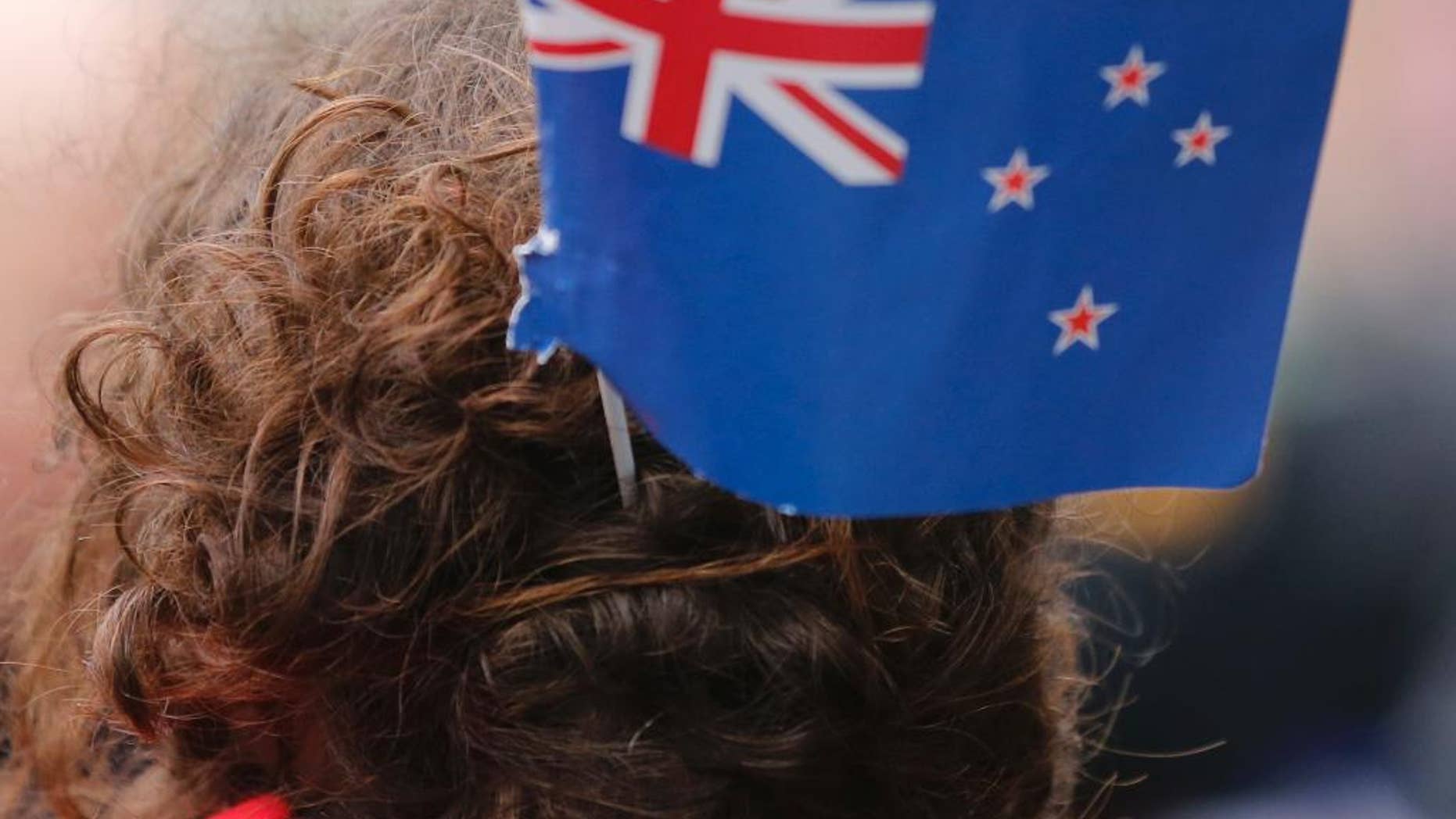 A rugby fan wears a New Zealand flag in her hair in October.