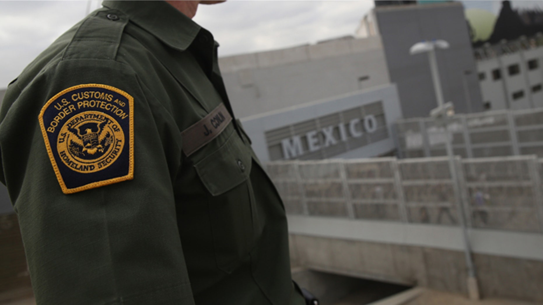 SAN YSIDRO, CA - OCTOBER 03: U.S. Border Patrol agent Jerry Conlin stands on the American side of the U.S.-Mexico border on October 3, 2013 at the San Ysidro port of enty into Mexico, California. While hundreds of thousands of government workers were furloughed due to the federal shutdown, thousands of Border Patrol agents, air-traffic controllers, prison guards and other federal employees deemed "essential" remain on duty, although their pay may be delayed. (Photo by John Moore/Getty Images)