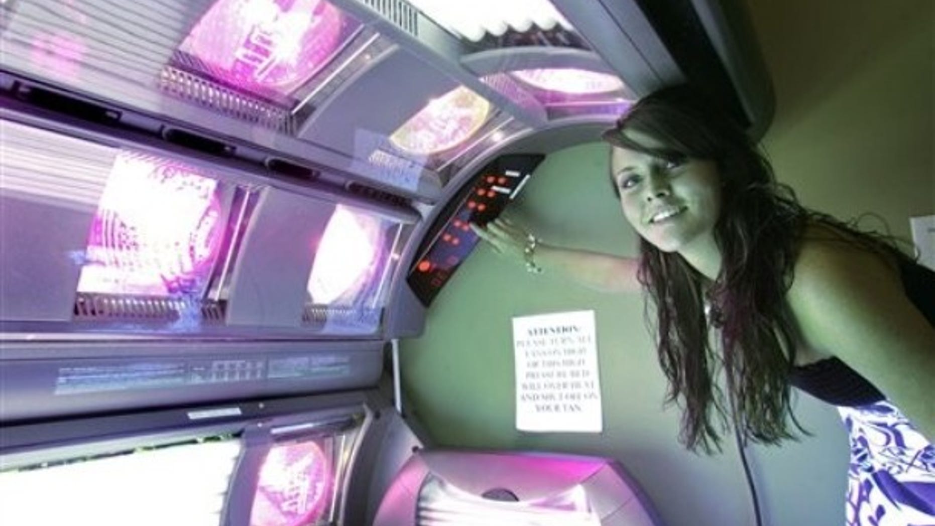 Rosie McDavid, 17, who has been using tanning beds since she was 14, prepares a tanning bed for a session, Wednesday, March 25, 2009, in Tallahassee, Fla. The Florida Legislature is considering a bill that would restrict tanning bed use by minors. (AP Photo/Phil Coale)