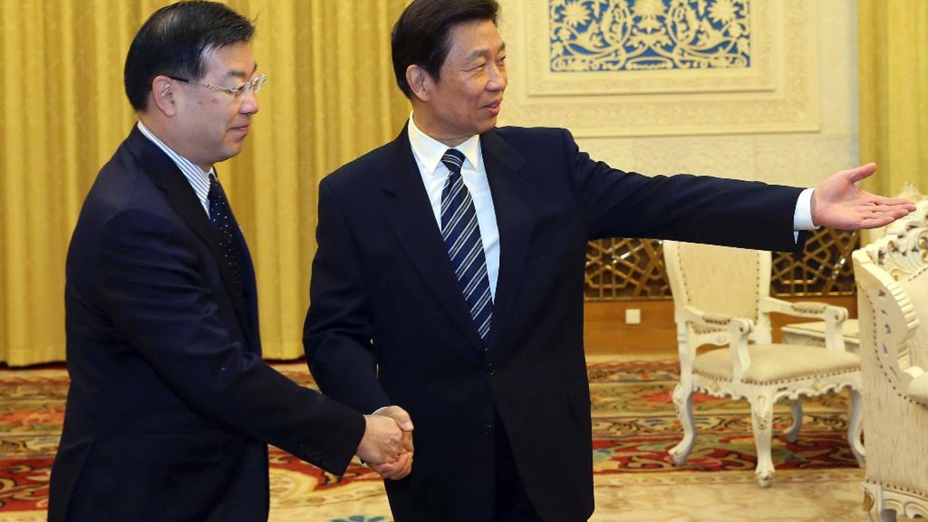 In this photo provided by China's Xinhua News Agency, Chinese Vice President Li Yuanchao, right, meets with President of Japan's National Governors' Association, Keiji Yamada, in Beijing, capital of China, Tuesday, Oct. 28, 2014. China's vice president met Tuesday with a delegation of governors from Japan amid strained bilateral ties, a rare high-level meeting that points to Japan's hopes of a summit between the two countries' leaders at a regional conference next month. (AP Photo/Xinhua, Liu Weibing) NO SALES
