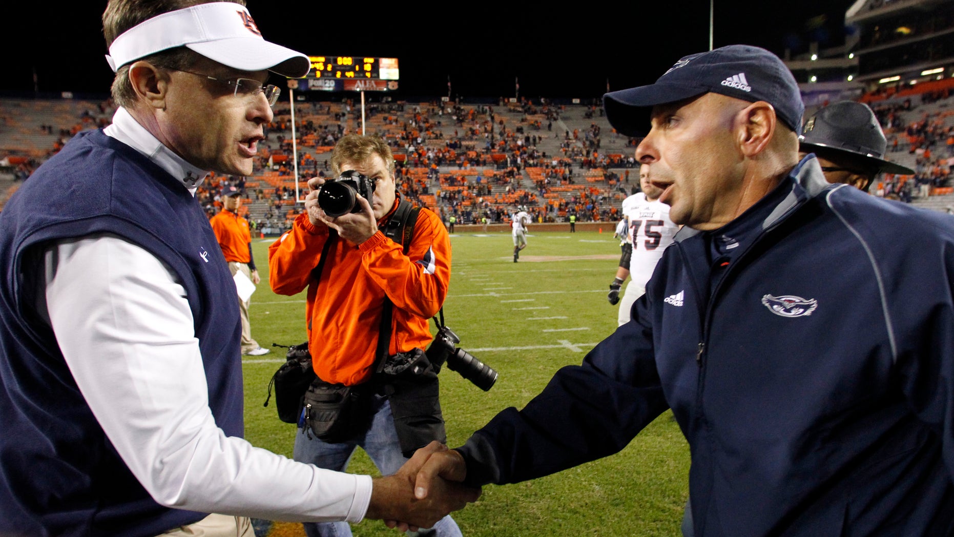 Auburn head coach Gus Malzahn, left, shakes hands with Florida Atlantic head coach Carl Pelini after defeating them 45-10 in an NCAA college football game on Saturday, Oct. 26, 2013, in Auburn, Ala. (AP Photo/Butch Dill)