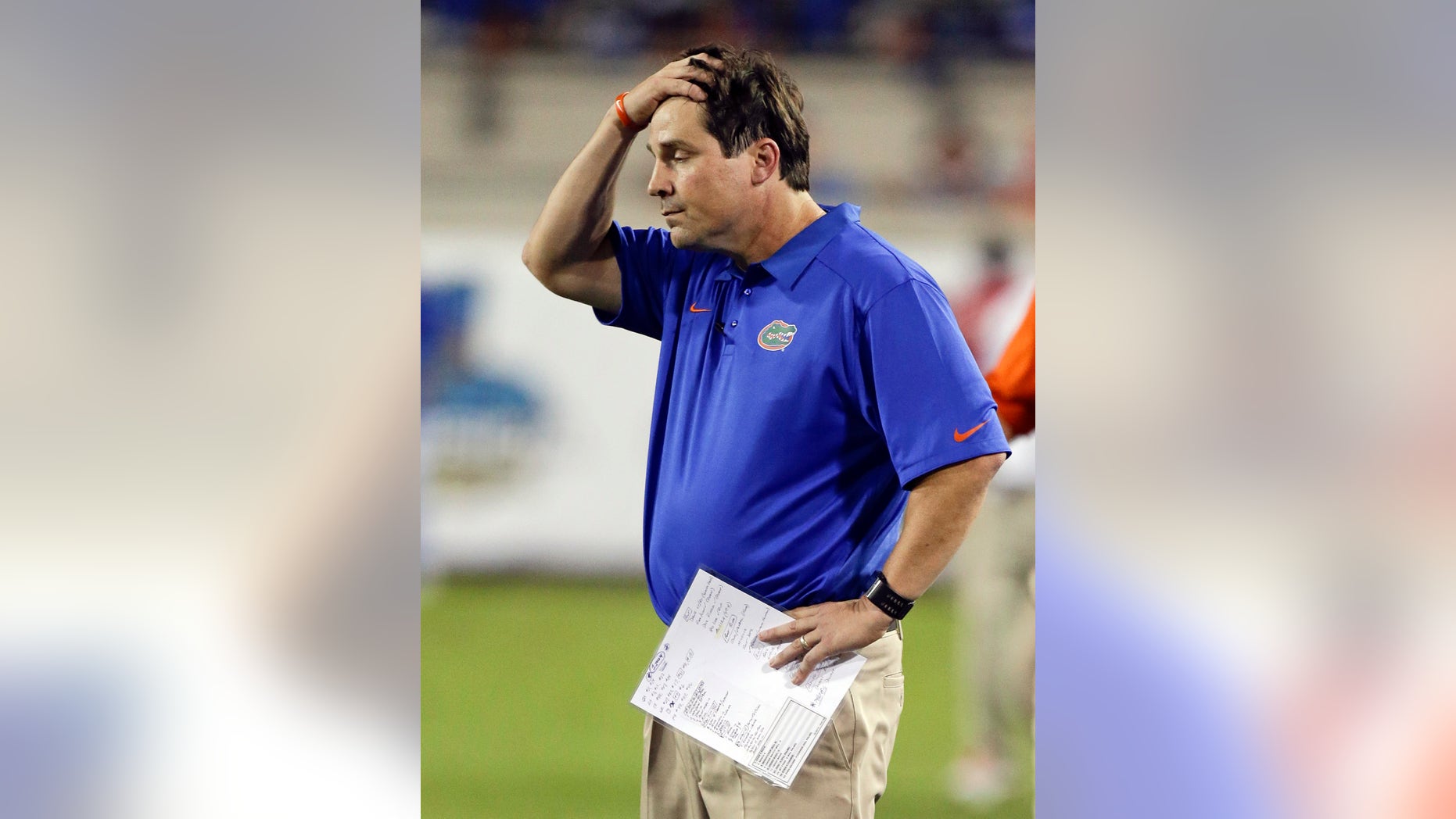 Florida head coach Will Muschamp holds his hand on his head as he watches the final moments of an NCAA college football game against Georgia in Jacksonville, Fla., Saturday, Nov. 2, 2013. Georgia won the game 23-20. (AP Photo/John Raoux)