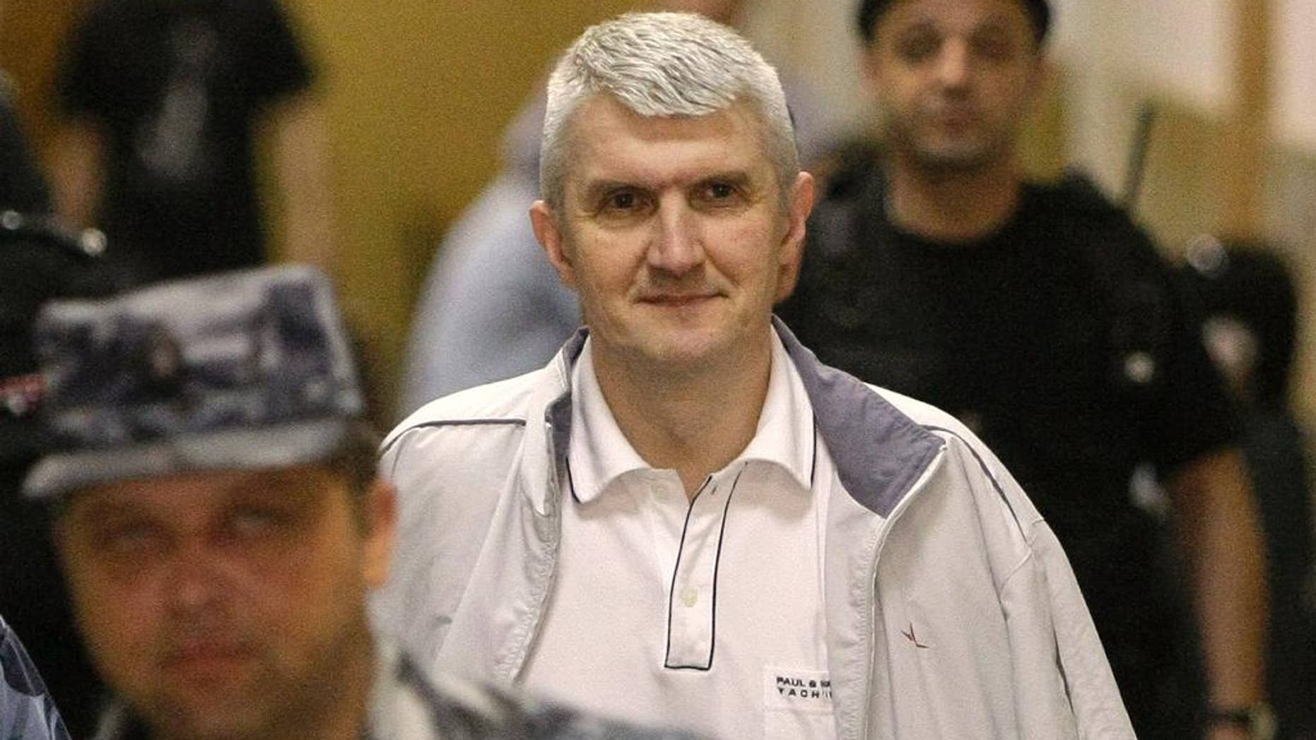 FILE - In this June 3, 2011 file photo, former Yukos CEO Mikhail Khodorkovsky's co-defendant Platon Lebedev, surrounded by guards, walks to a courtroom in Moscow. The Russian state has won three court cases recently in France that had entangled rocket builders in Yukos' efforts to recover money it says the Kremlin unfairly appropriated. Four more rulings are expected Friday April 15, 2016 in Paris. (AP Photo/Misha Japaridze, file)