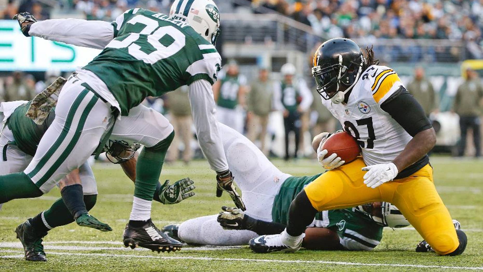 Pittsburgh Steelers running back LeGarrette Blount (27) is tackled by New York Jets' Quinton Coples as Jets' Antonio Allen (39) closes in near the goal line during the second half of an NFL football game Sunday, Nov. 9, 2014, in East Rutherford, N.J. (AP Photo/Kathy Willens)