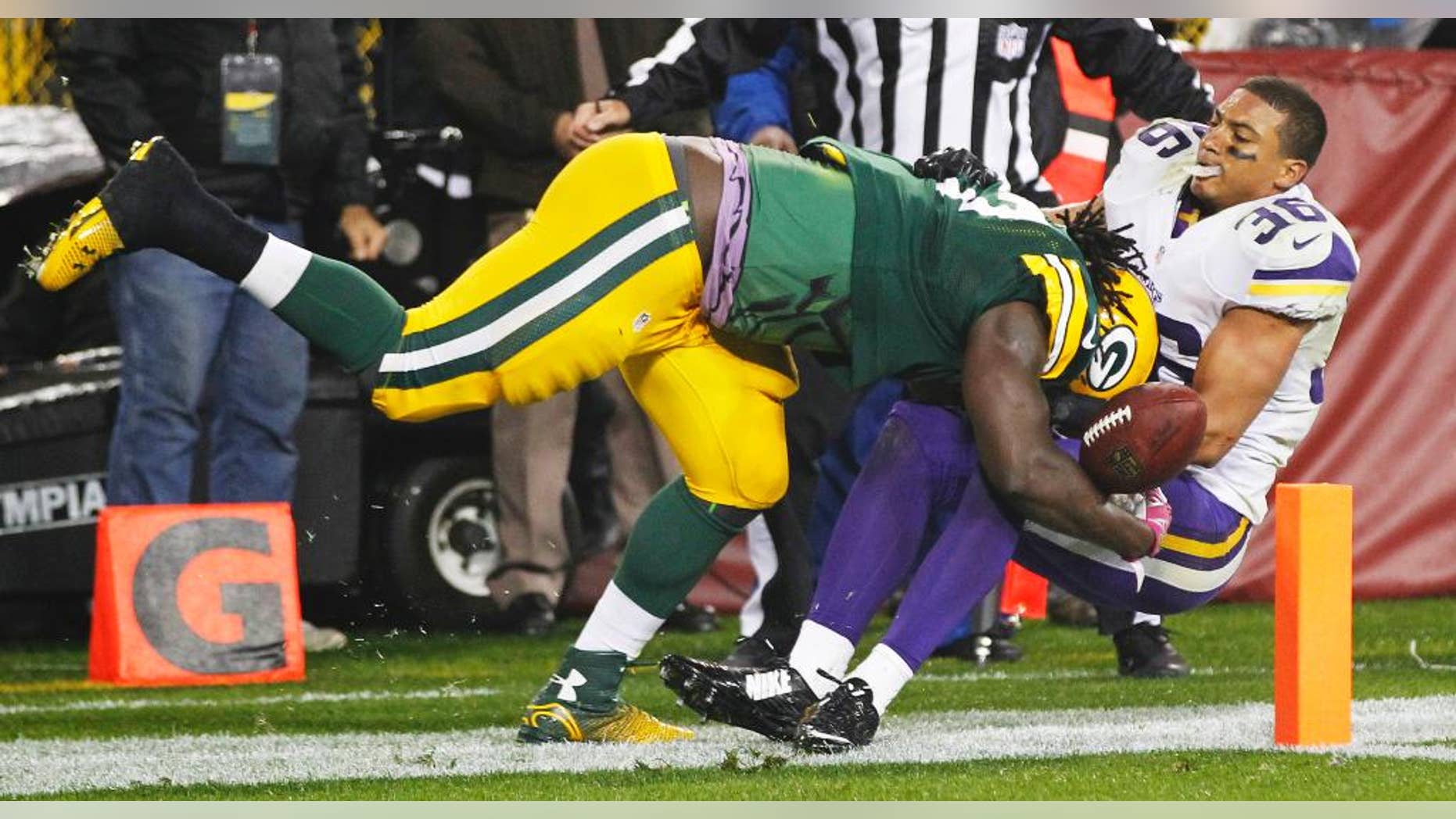 Green Bay Packers' Eddie Lacy gets past Minnesota Vikings' Robert Blanton (36) for a 10-yard touchdown run during the second half of an NFL football game Thursday, Oct. 2, 2014, in Green Bay, Wis. (AP Photo/Mike Roemer)