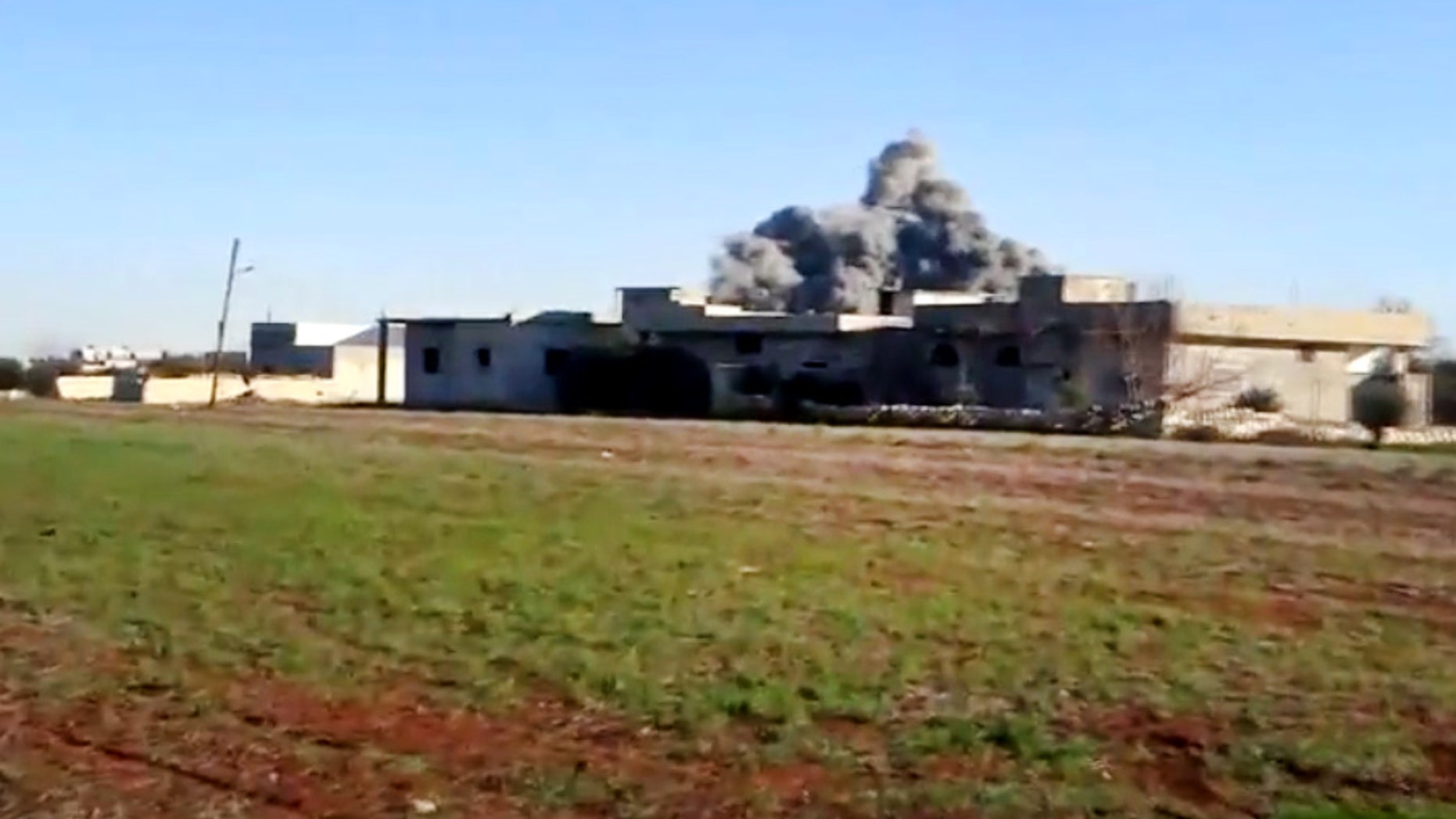 In this image taken from video obtained from the Shaam News Network, which has been authenticated based on its contents and other AP reporting, smoke rises due to heavy shelling in Taftanaz, Idlib province, northern Syria, on Thursday, Jan. 10, 2013. (AP Photo/Shaam News Network via AP video)