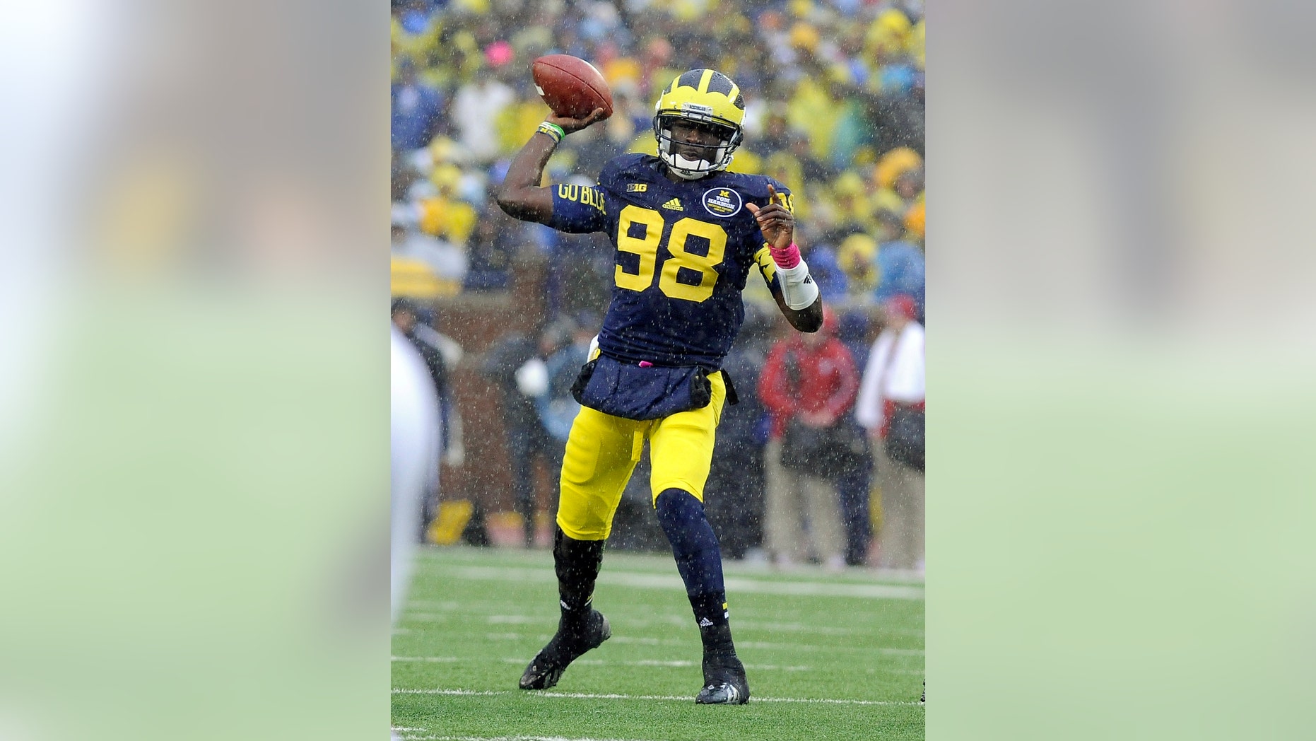 FILE - In this Oct. 19, 2013 file photo, Michigan quarterback Devin Gardner throws a pass in the rain during an NCAA college football game against Indiana in Ann Arbor, Mich. Heading into the final month of regular season Michigan is battling for supremacy in the Big Ten’s Legends Division with Michigan State and Nebraska. (AP Photo/Lon Horwedel, File)