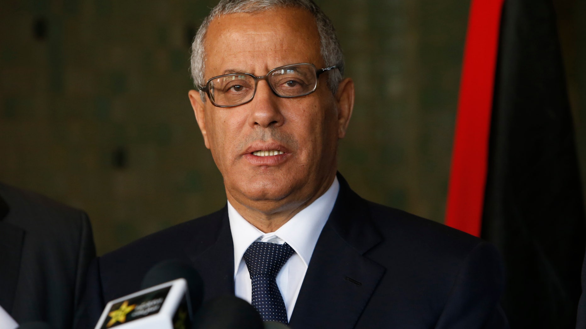 FILE - In this Tuesday, Oct. 8, 2013 file photo, Libyan's Prime Minister Ali Zidan speaks to the media during a press conference in Rabat, Morocco. Zidan was snatched by gunmen before dawn Thursday from a Tripoli hotel where he resides, the government said. The abduction appeared to be in retaliation for the U.S. special forces' raid over the weekend that seized a Libyan al-Qaida suspect from the streets of the capital. (AP Photo/Abdeljalil Bounhar)