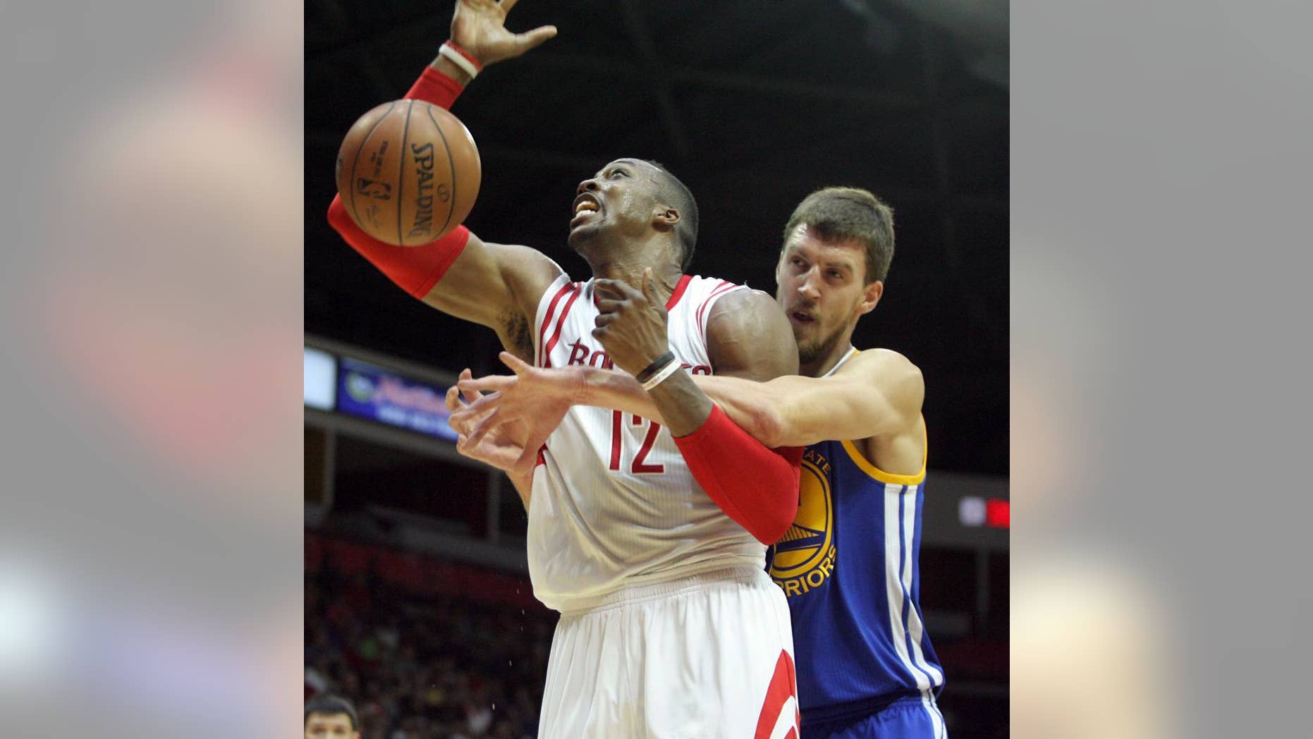 Houston Rockets Dwight Howard, left, gets fouled by Golden State Warriors defender David Lee during the first half of an NBA preseason basketball game in Hidalgo, Texas, Sunday, Oct. 19, 2014. (AP Photo/Delcia Lopez)