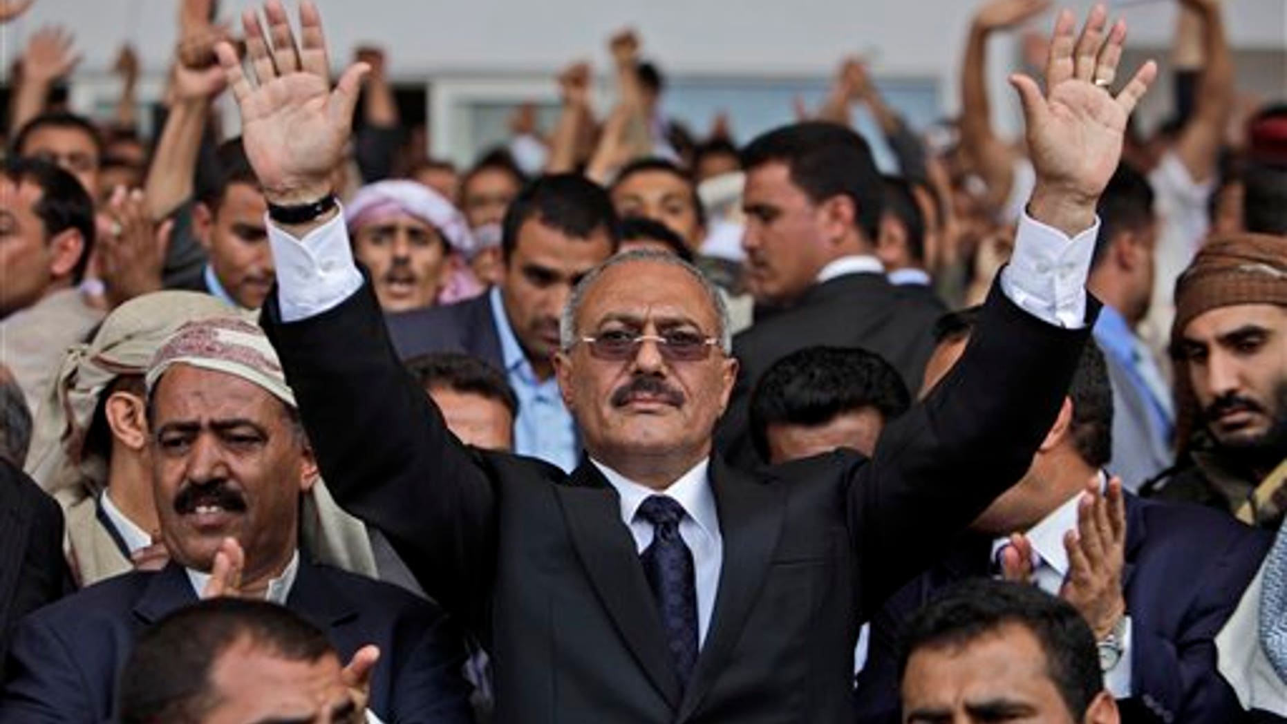 In this April 15, 2011, file photo Yemeni President Ali Abdullah Saleh waves to his supporters during a rally in Sanaa, Yemen. The head of a coalition of Gulf countries seeking to broker an end to Yemen's political crisis gave up on Wednesday and left the country, opposition and government leaders said. Yemen is reeling from three months of massive street protests demanding the ouster of President Ali Abdullah Saleh after more than three decades in power. (AP/File)
