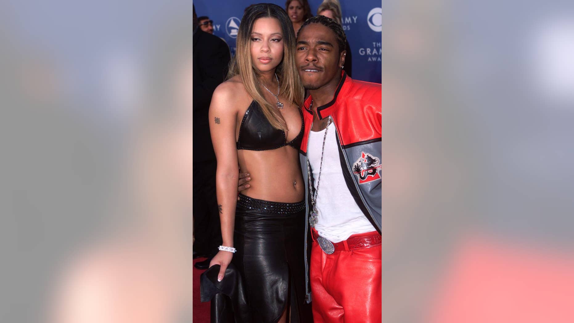 Rapper Sisqo (right) and his girlfriend Tara arrive at the 43rd annual Grammy Awards in Los Angeles on February 21, 2001.