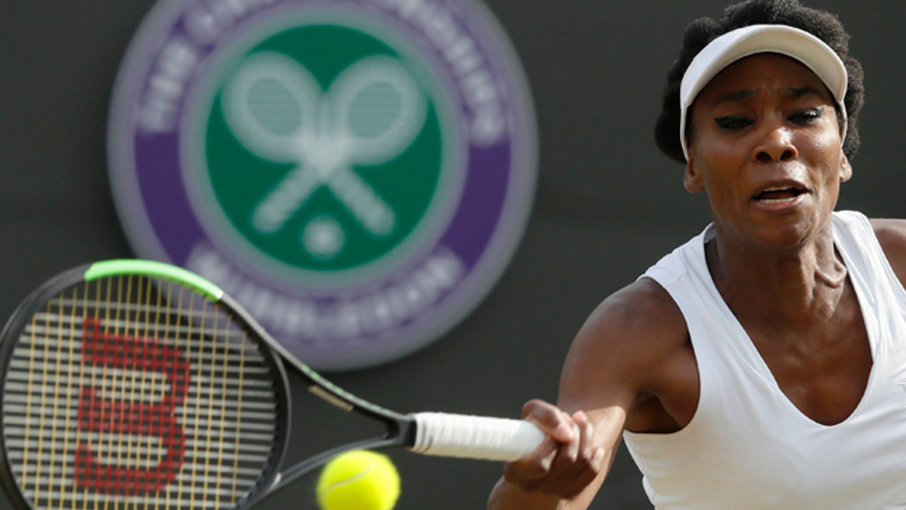 Venus Williams of the United States returns to Japan's Naomi Osaka during their Women's Singles Match on day five at the Wimbledon Tennis Championships in London Friday, July 7, 2017. (AP Photo/Kirsty Wigglesworth)