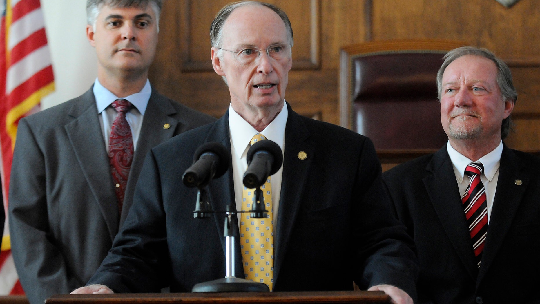 Alabama Gov. Robert Bentley sAlabama Gov. Robert Bentley is flanked by Sen. Scott Beason, R-Gardendale, left, and Micky Hammon, R-Decatur, right, as he speaks before signing into law what critics and supporters are calling the strongest bill in the nation cracking down on illegal immigration, on Thursday June 9, 2011 at the state Capitol in Montgomery, Ala. The bill allows police to arrest anyone suspected of being an illegal immigrant if they're stopped for any other reason. It also requires public schools to determine students' immigration status and makes it a crime to knowingly give an illegal immigrant a ride. (AP Photo/Montgomery Advertiser, Mickey Welsh)