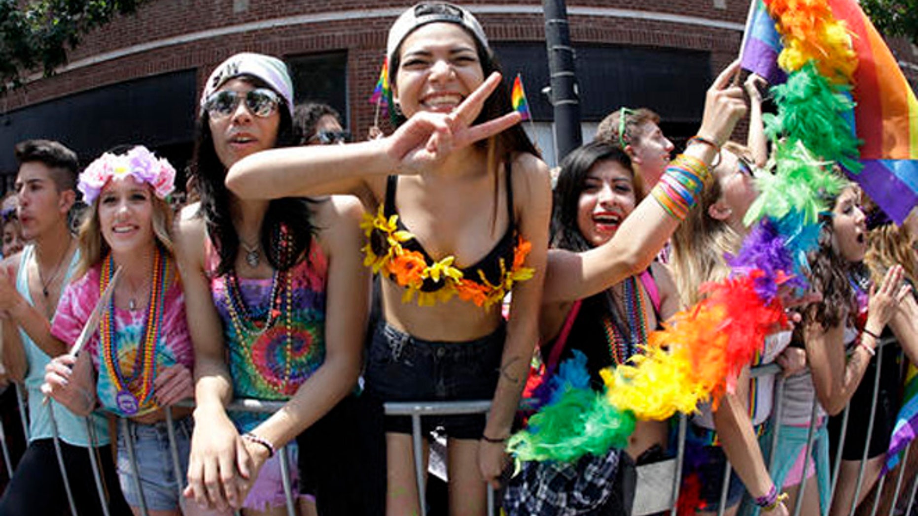 In this June 28, 2015 file photo, people smile and gesture during the annual Chicago Pride Parade in Chicago.