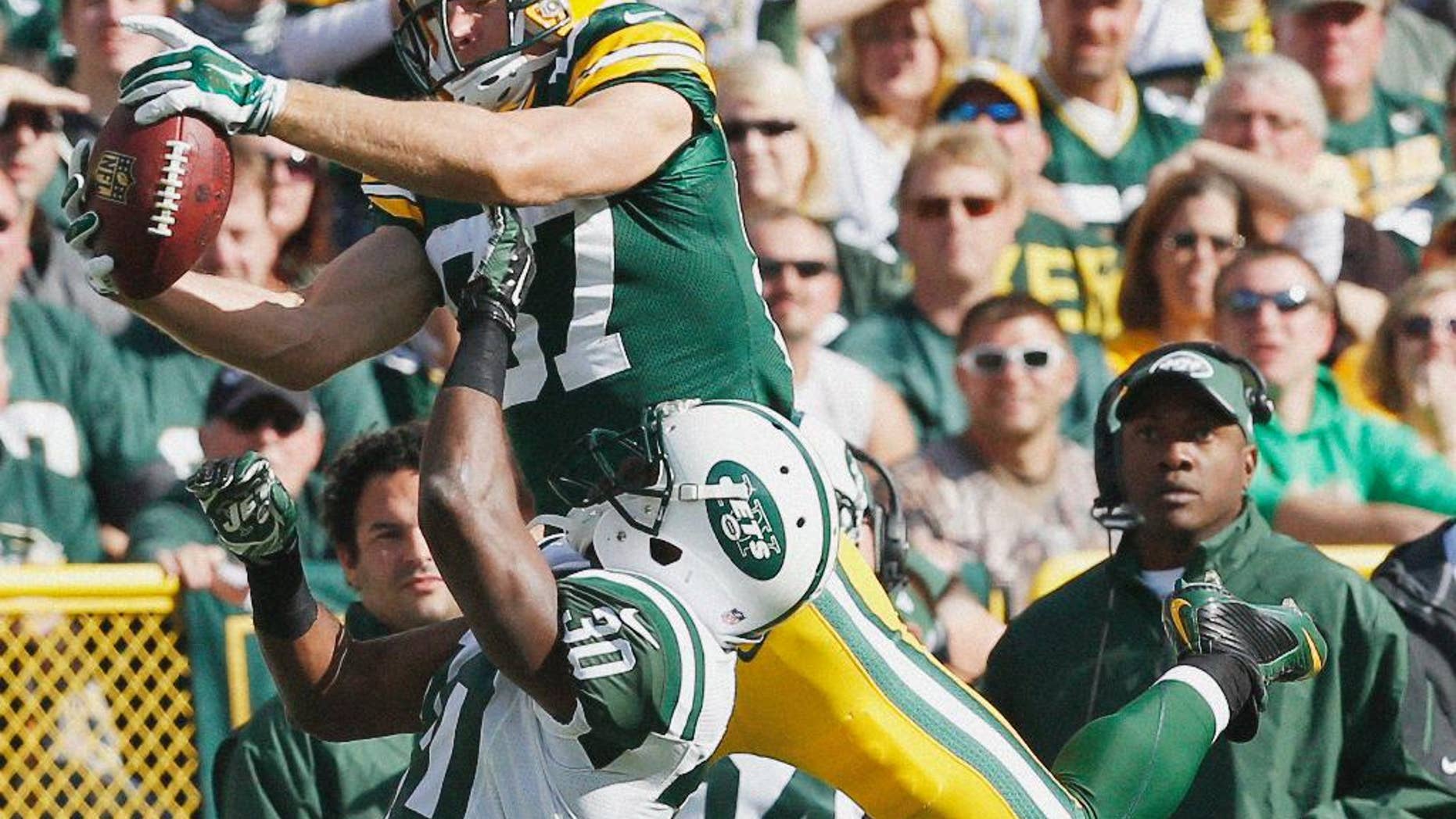 New York Jets fans react after a touchdown catch was called back because the team called a time out before the ball was snapped during the second half of an NFL football game against the Green Bay Packers Sunday, Sept. 14, 2014, in Green Bay, Wis. (AP Photo/Mike Roemer)