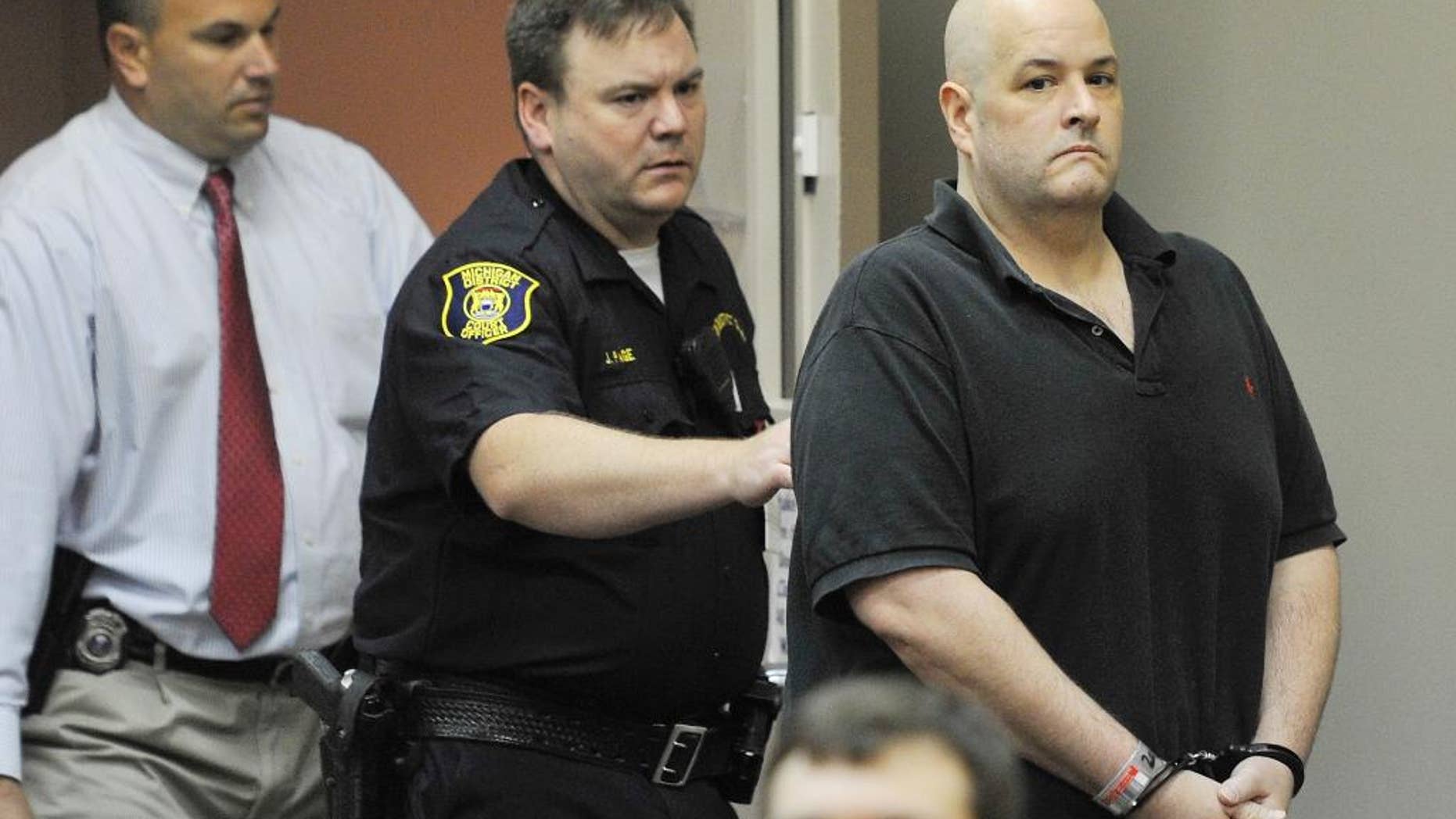 FILE- In an Aug. 20, 2012 file photo, Roger Bowling, right, is escorted into a courtroom by police and detectives for a preliminary examination at the 24th District Court in Allen Park, Mich. Jury selection is getting underway in the trial of Bowling is charged with killing a couple and dumping their body parts in the Detroit River. Bowling is charged in the deaths of 32-year-old Danielle Greenway and 42-year-old Chris Hall, who were killed in 2012 at their home in Allen Park. Trial is starting Monday, Aug. 11, 2014, with jury selection in Wayne County court. (AP Photo/The Detroit News, Daniel Mears_File)