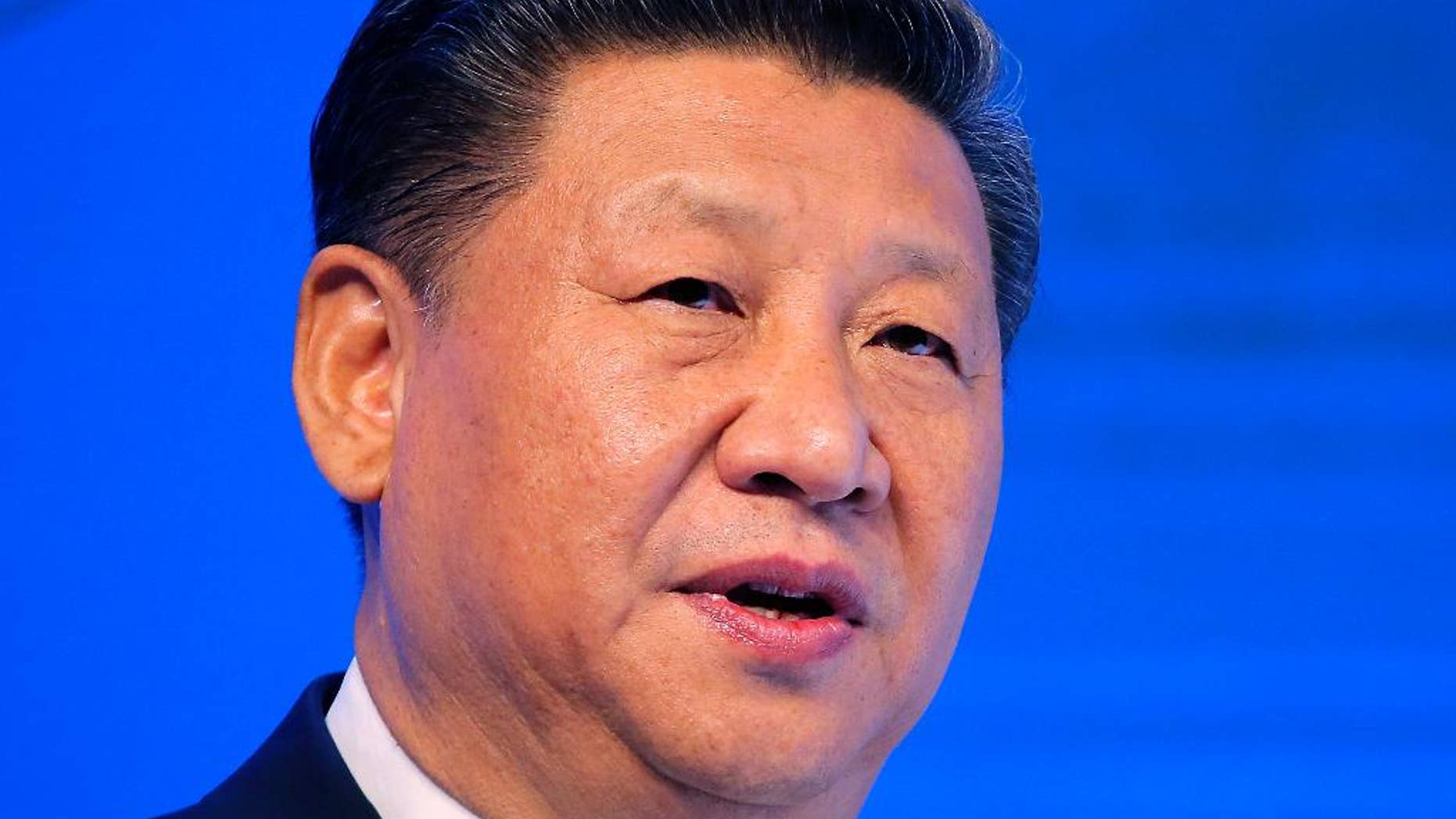 FILE - In this Jan. 17, 2017, file photo, Chinese President Xi Jinping speaks at the World Economic Forum in Davos, Switzerland. U.S. President Donald Trump has reaffirmed America’s long-standing “one China” policy in a telephone conversation with Xi that could alleviate concerns about a major shift in Washington’s approach to relations with Beijing. The long-awaited call came Thursday, Feb. 9, 2017, Washington time, the White House and China’s state broadcaster CCTV said. (AP Photo/Michel Euler, File)