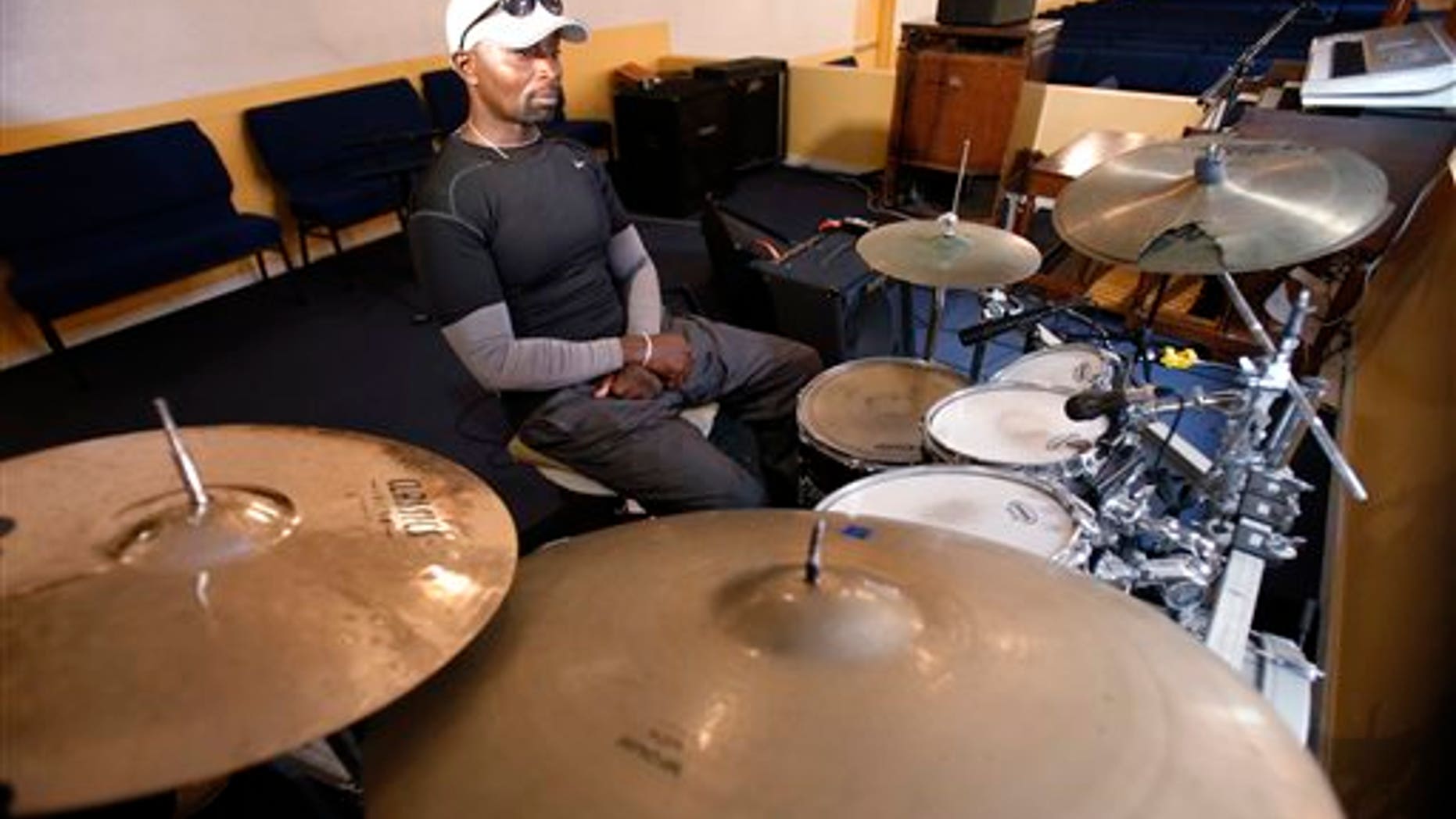 Fred Banks, uncle of 31-year-old Corey Jones who was shot and killed by a South Florida police officer, sits at the drum set that Jones played in church. (AP Photo/Wilfredo Lee)