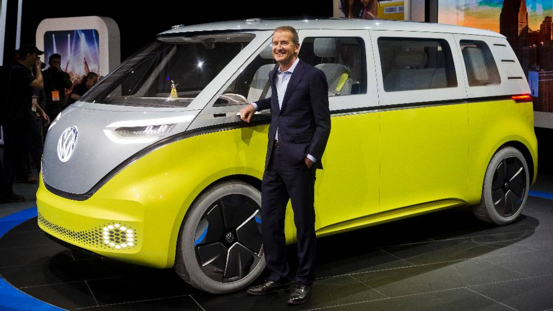 Dr. Herbert Diess, chairman of the Volkswagen brand, poses with the I.D. Buzz all-electric concept van, at the North American International Auto Show, Monday, Jan. 9, 2017, in Detroit. (AP Photo/Tony Ding)