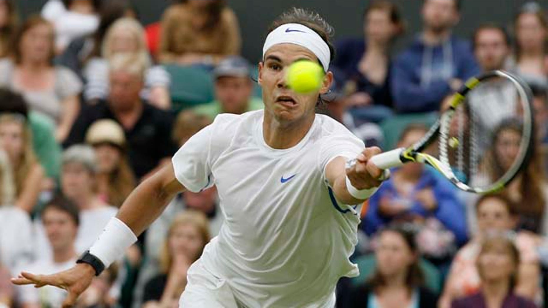 Spain's Rafael Nadal returns a shot to Ryan Sweeting of the US at the All England Lawn Tennis Championships at Wimbledon, Wednesday, June 22, 2011. (AP Photo/Kirsty Wigglesworth)